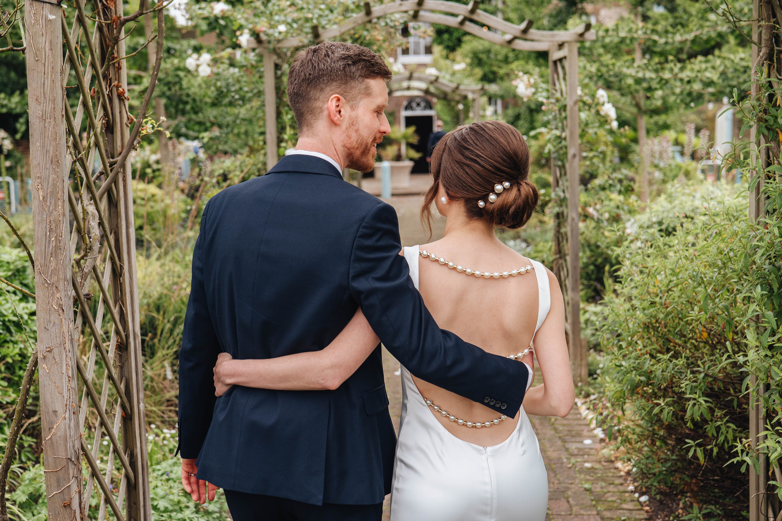 bride and groom from the back, hugging each other