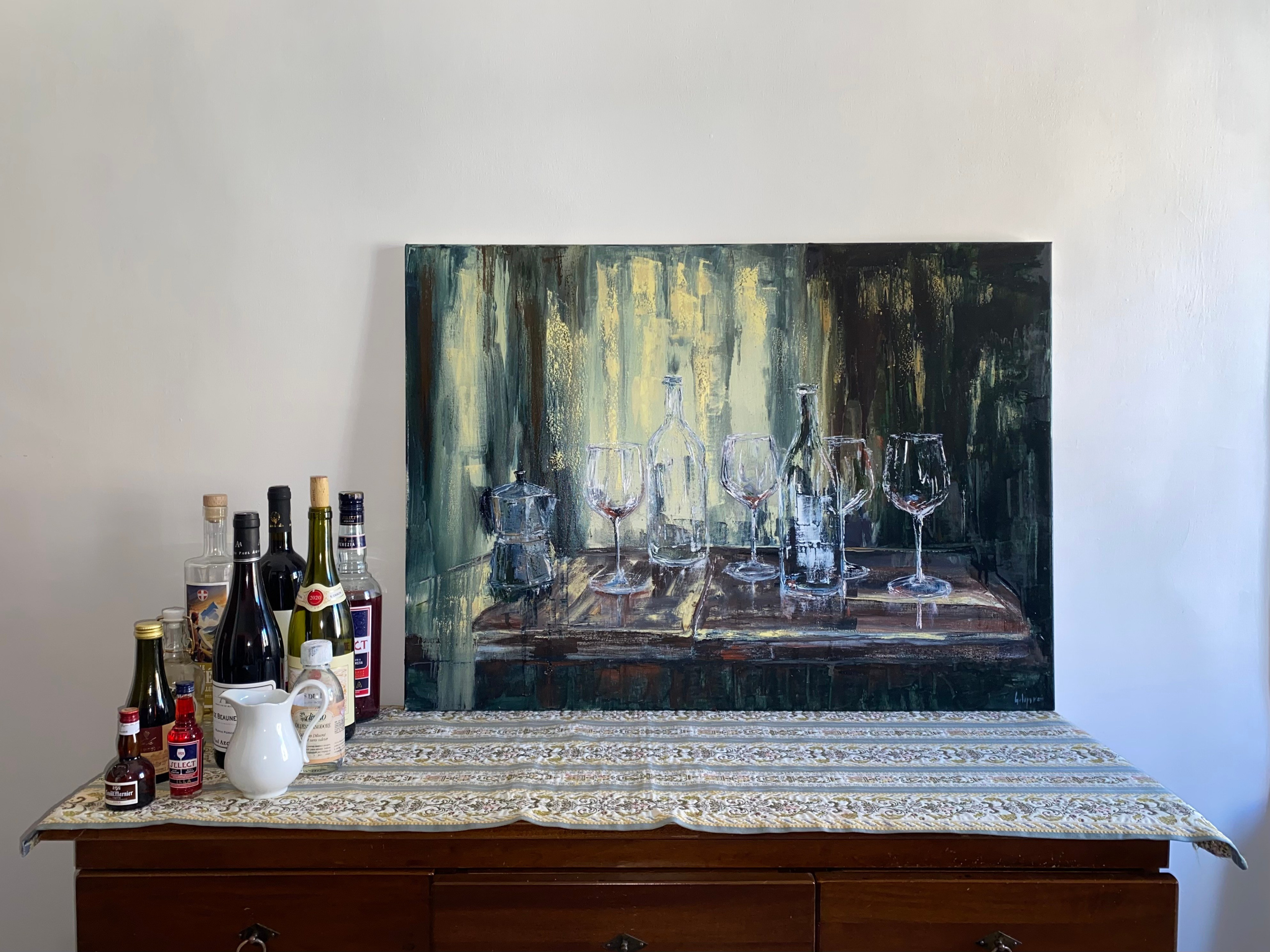 Expressive oil still life of a bar table with bottles, wine glasses, by Ekaterina Solopova showing aperitivo time.