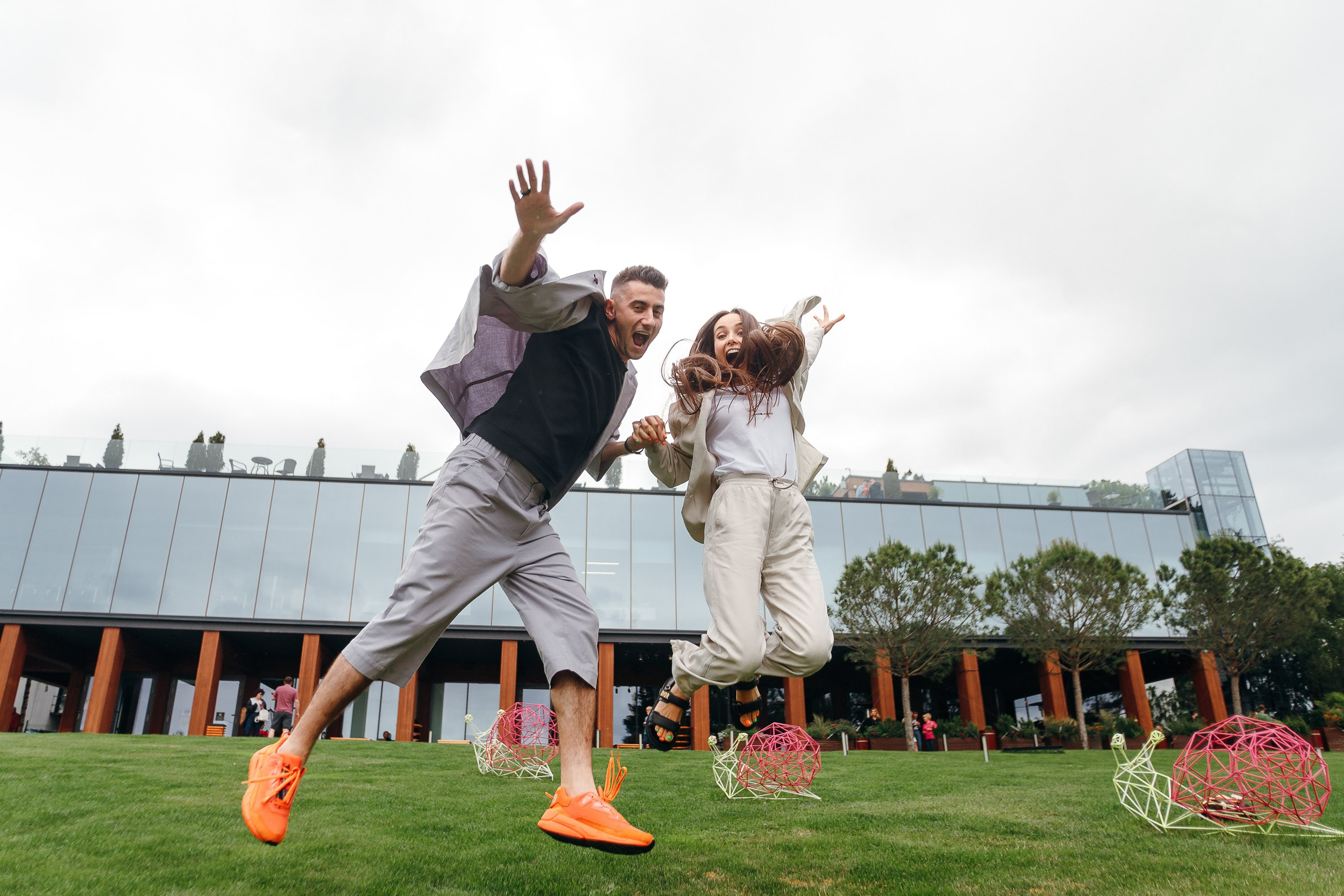 Man lifting woman in field, joyful engagement photo