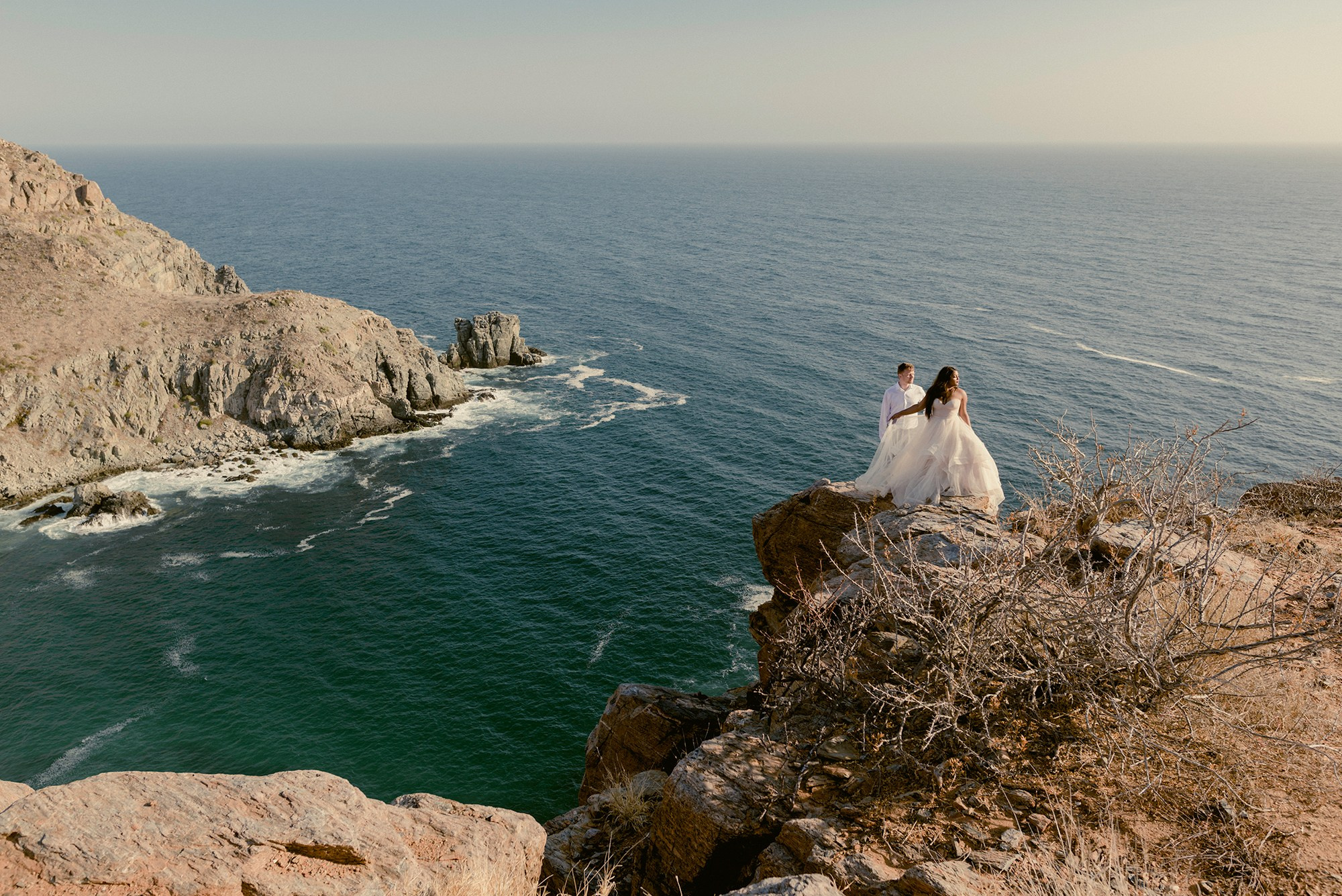 Trash the dress session at Punta Lobos Todos Santos – couple on cliff overlooking Pacific Ocean, cinematic destination photography in Baja California Sur