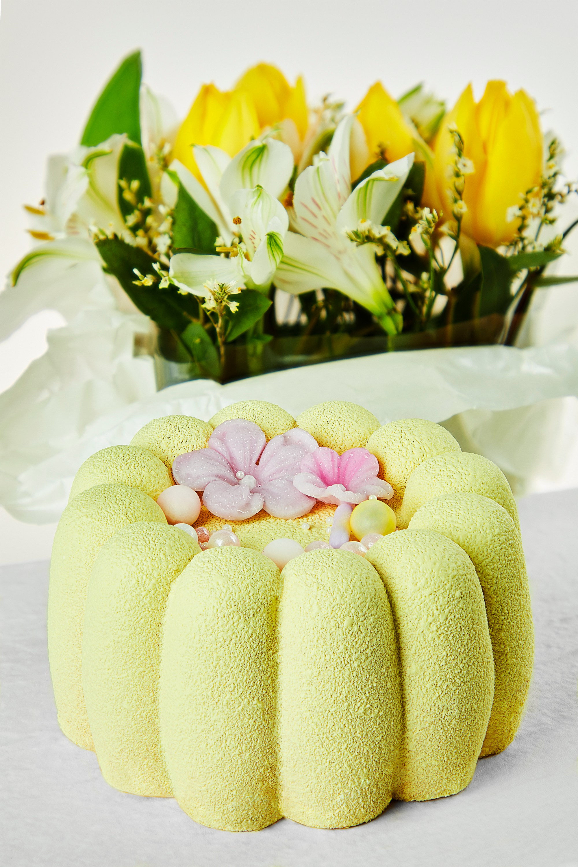 Photographer Roman Djuzev - Yellow Cake In Close-up With Flowers In The Background.
