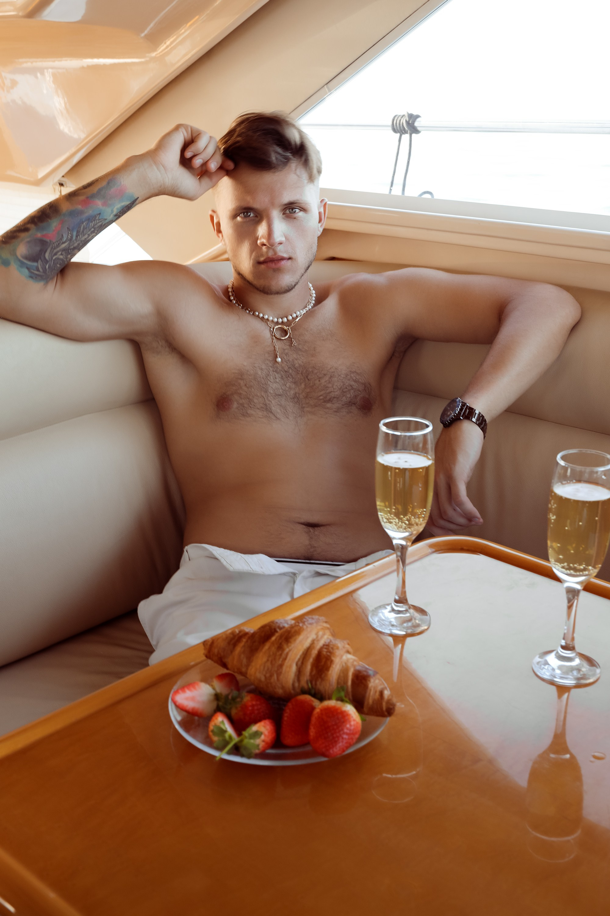 A man looks at the photographer at the yacht. Dubai, United Arab Emirates