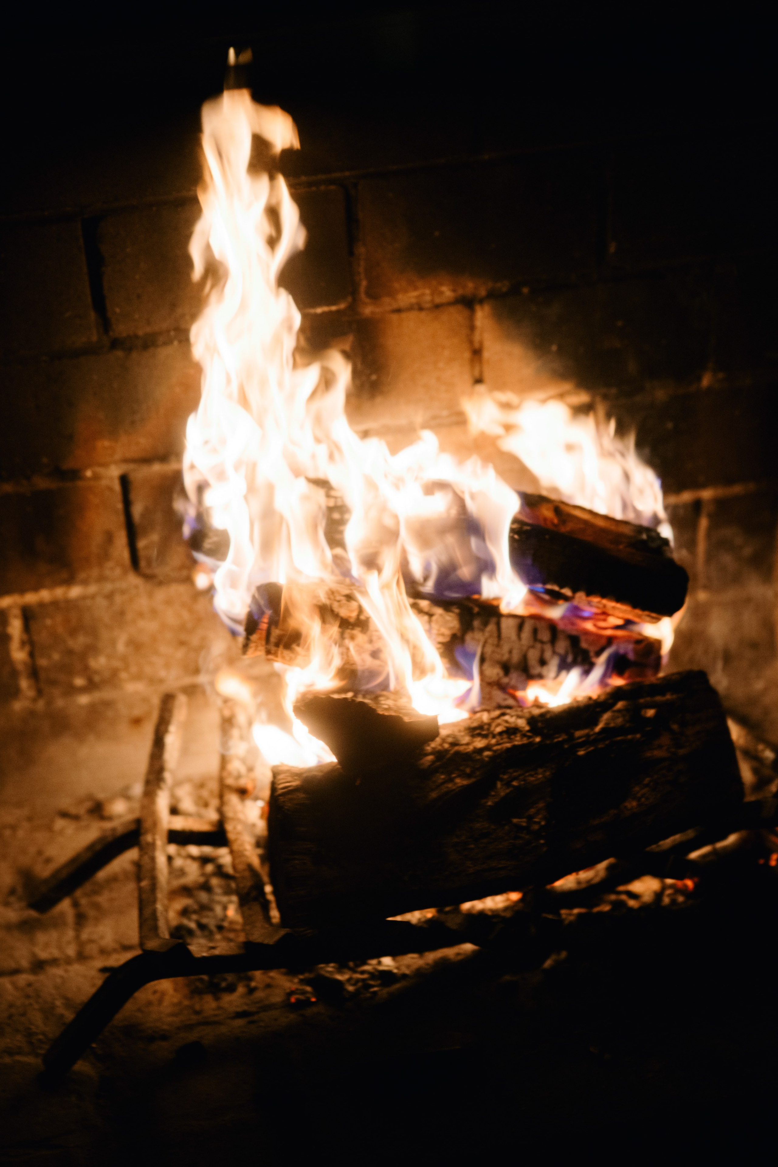 a fire burning in a brick fireplace