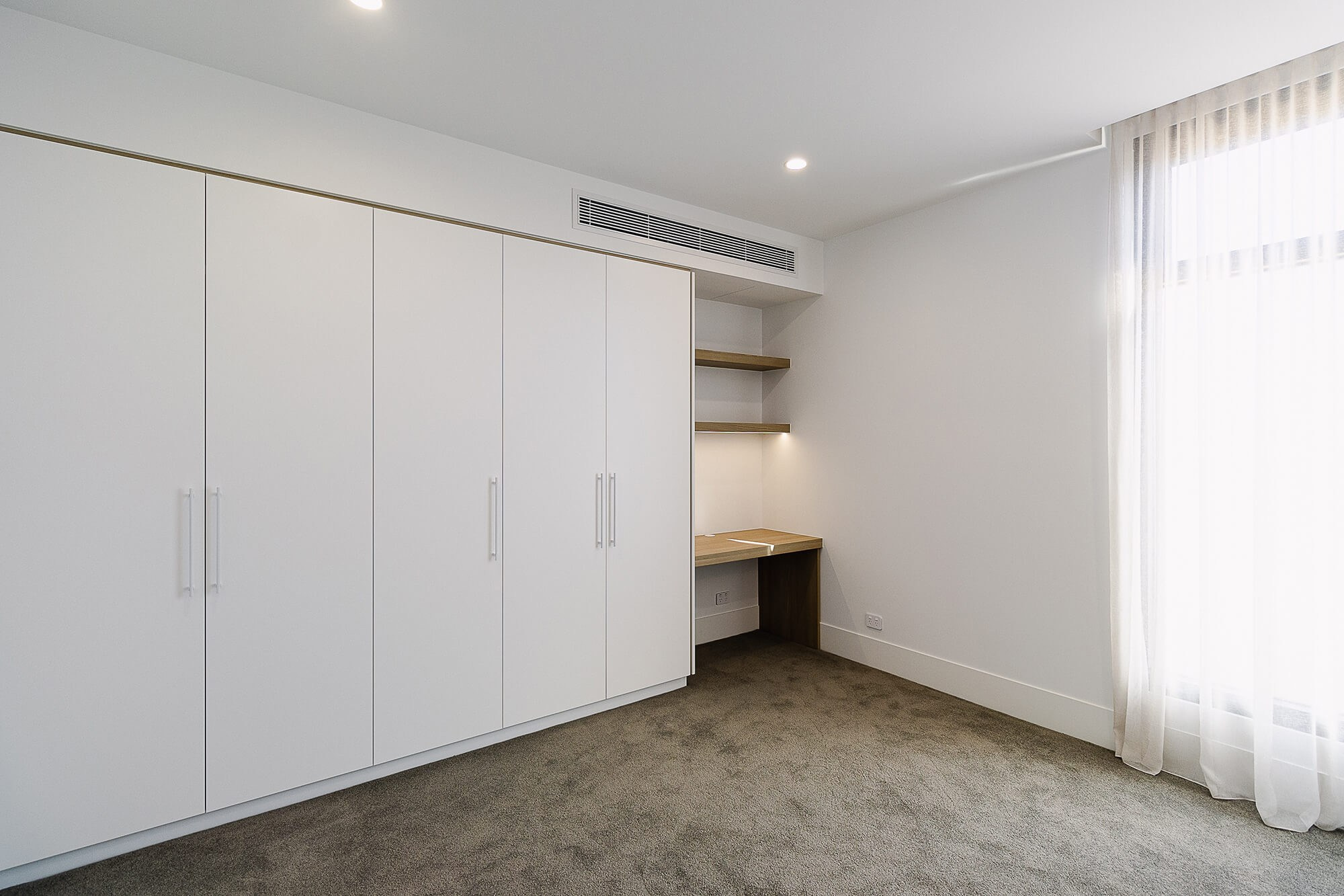 Elegant bedroom interior with minimalist decor – real estate photo