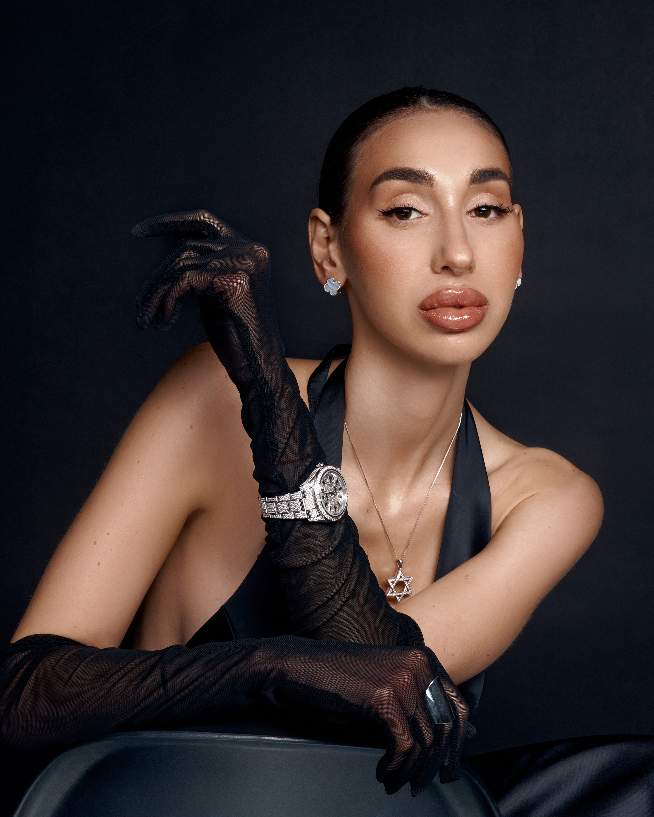 A refined studio portrait capturing inner strength, femininity and quiet confidence through clean light and a black backdrop.