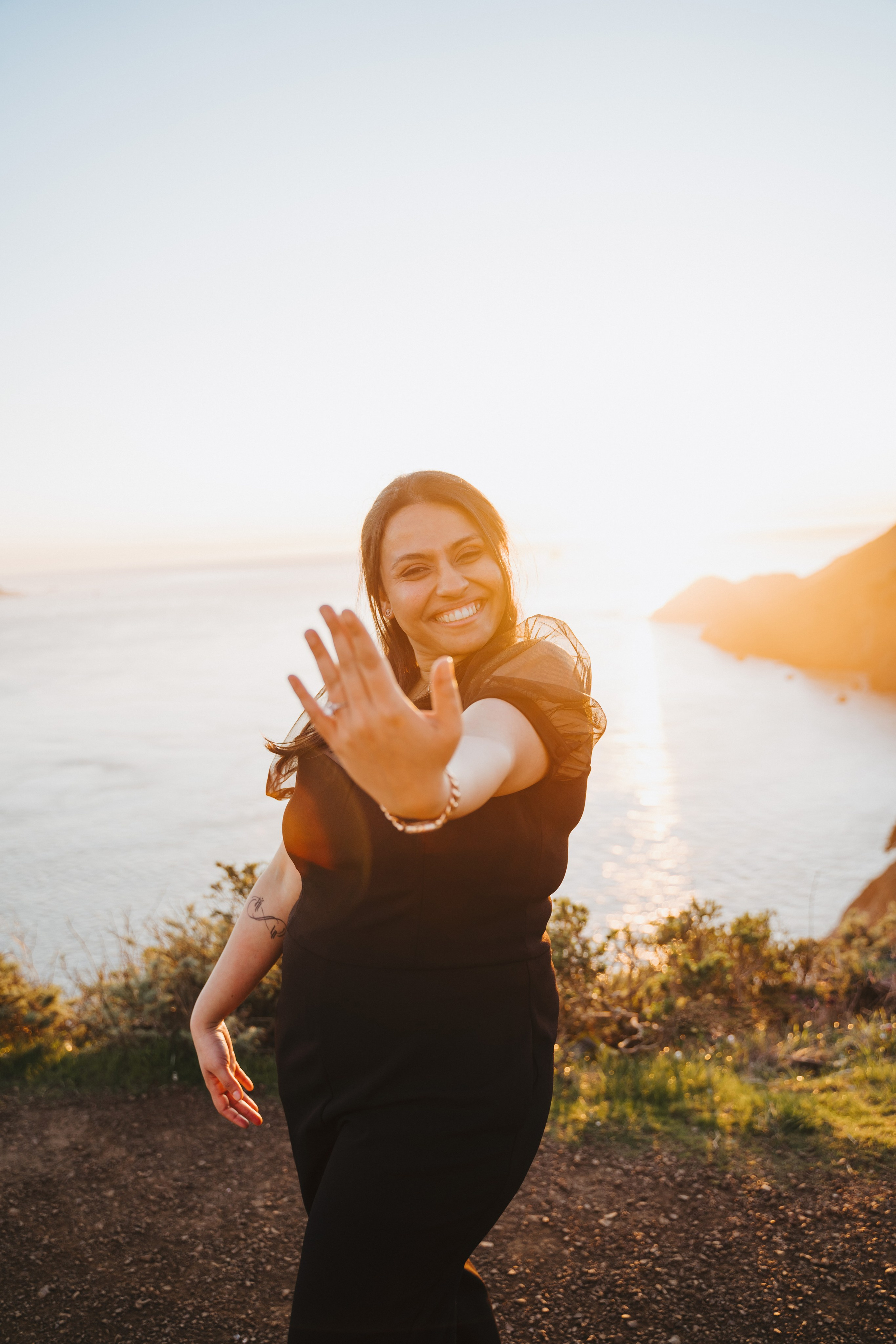 Proposal.  Overlooking the golden San Franisco Bridge sunset with a couple. Photographer Video. 