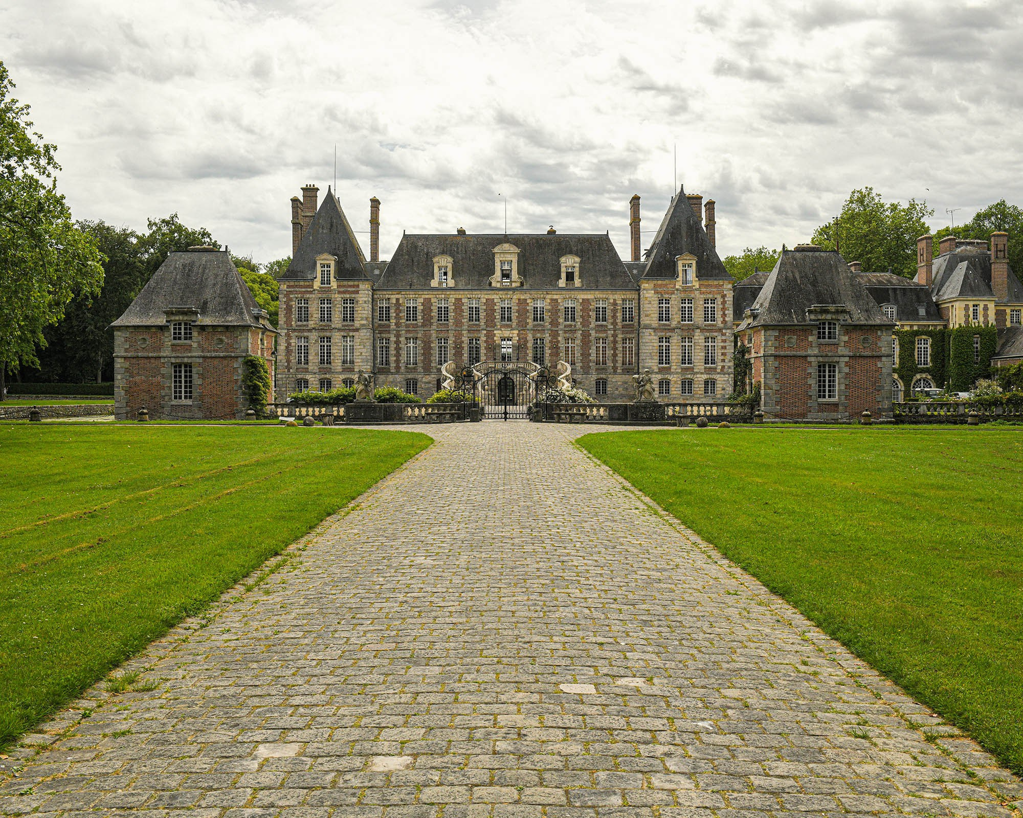 Main facade of Château de Courances historic estate near Paris, France