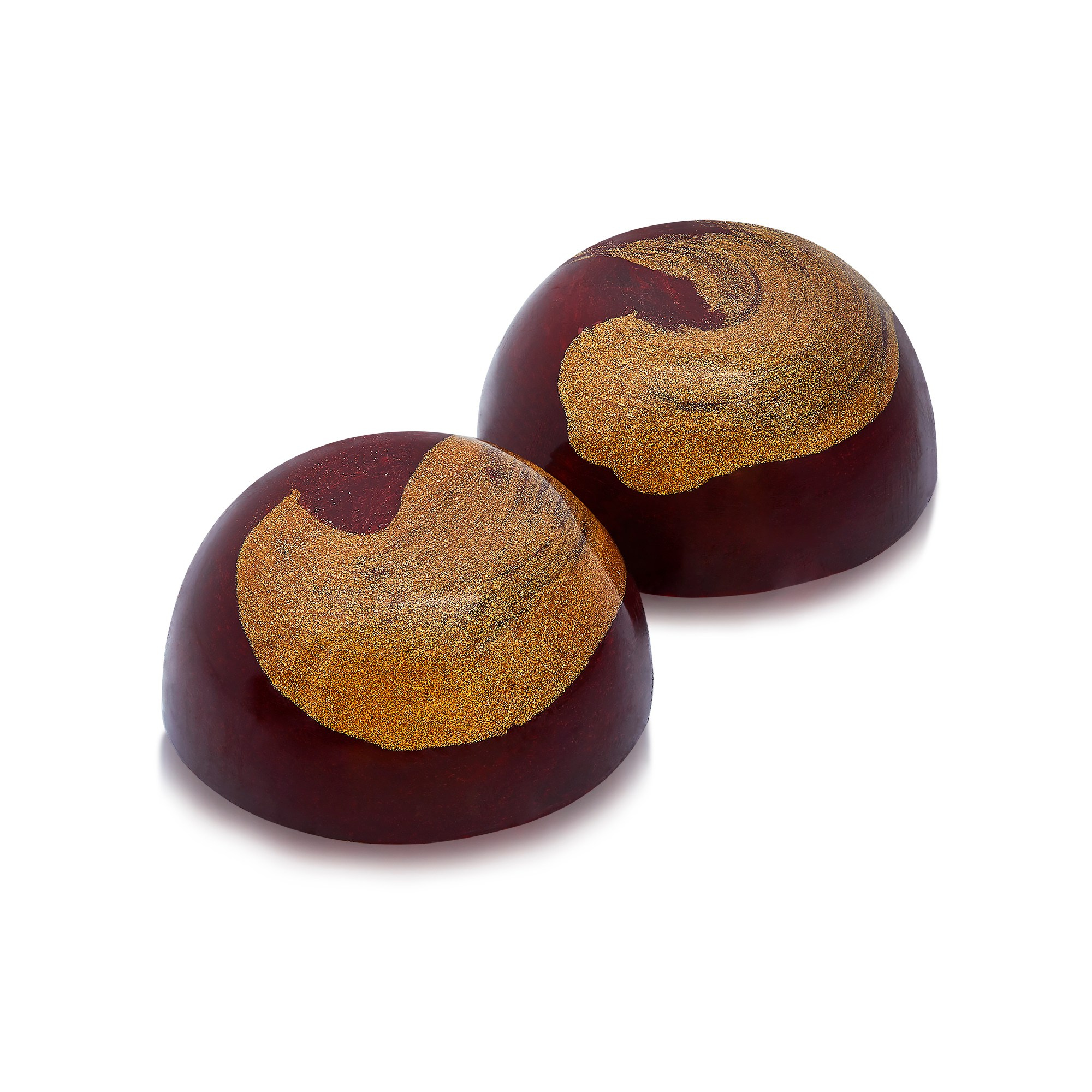 Photographer Roman Djuzev - Two handmade chocolate candies in golden glaze and half ball shape, on white background.