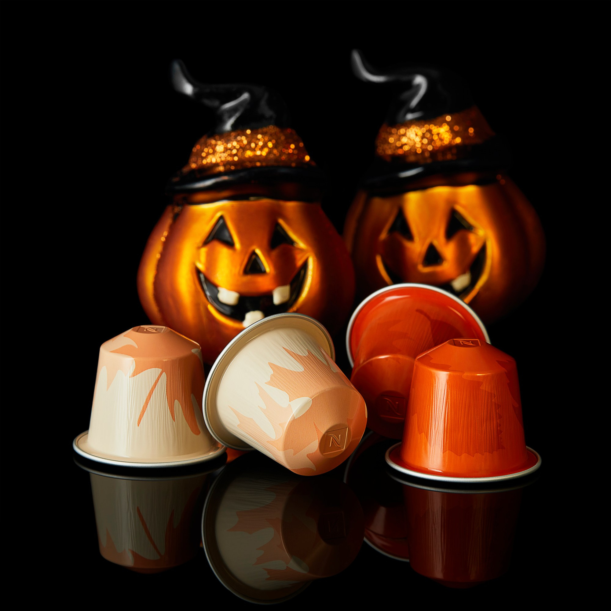 Photographer Roman Djuzev - Capsule coffee by Nespresso, Halloween series, close-up on a black background with reflection.