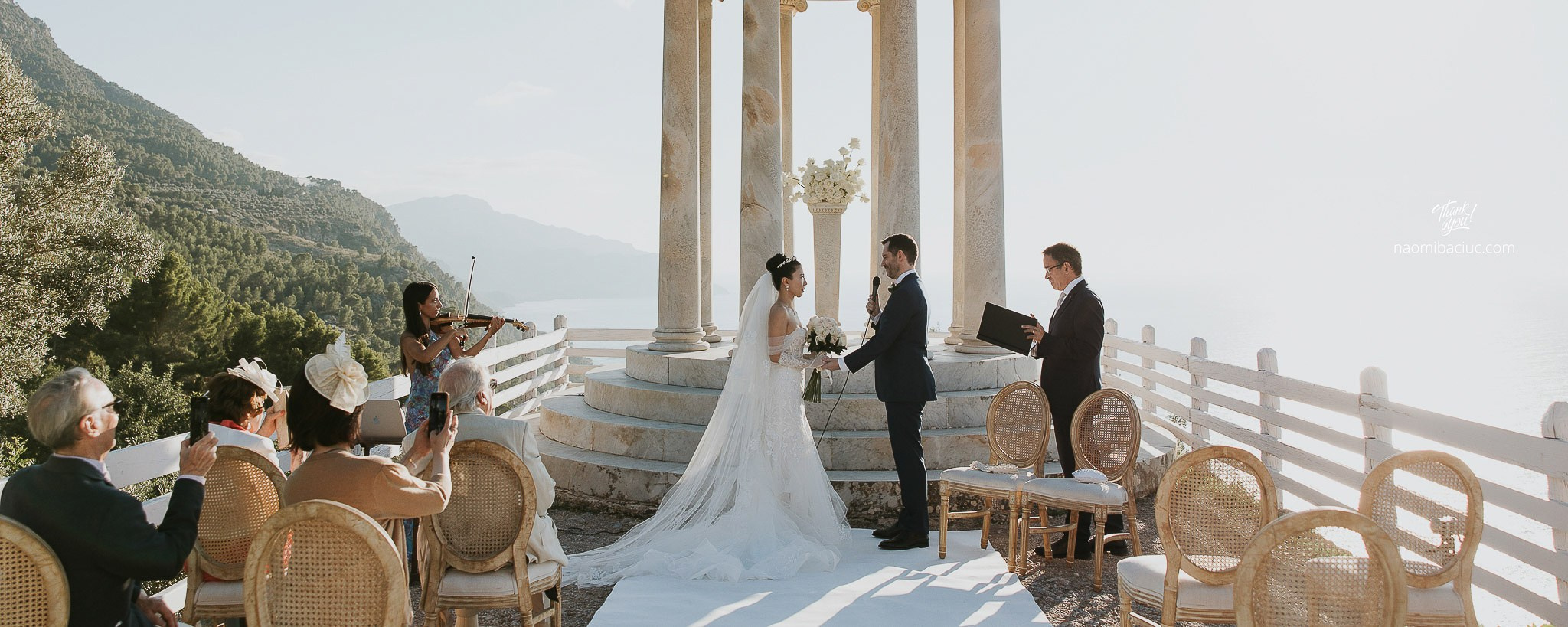Bride and groom facing Son Marroig temple altar