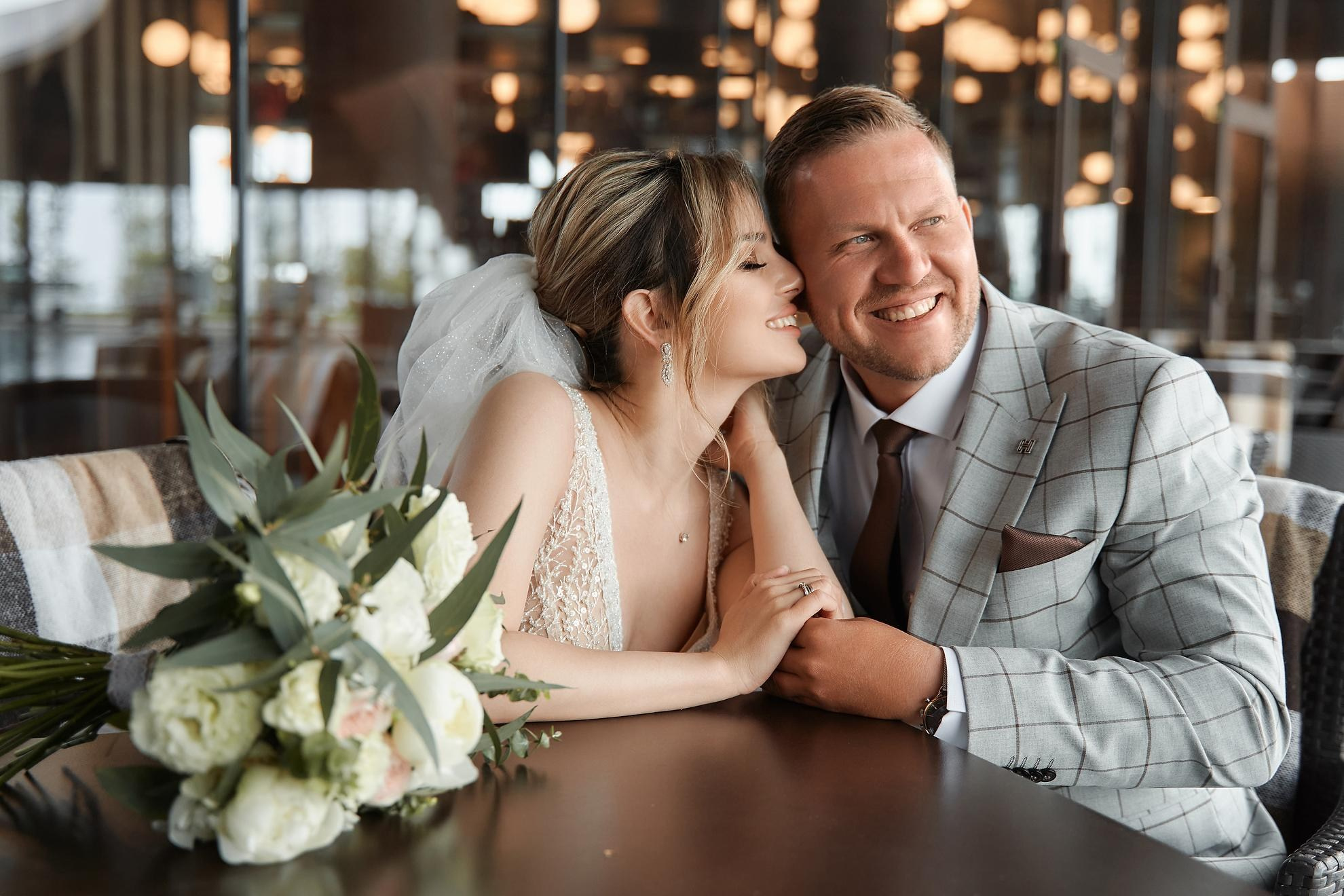 Wedding photography of bride and groom laughing together at reception in New York