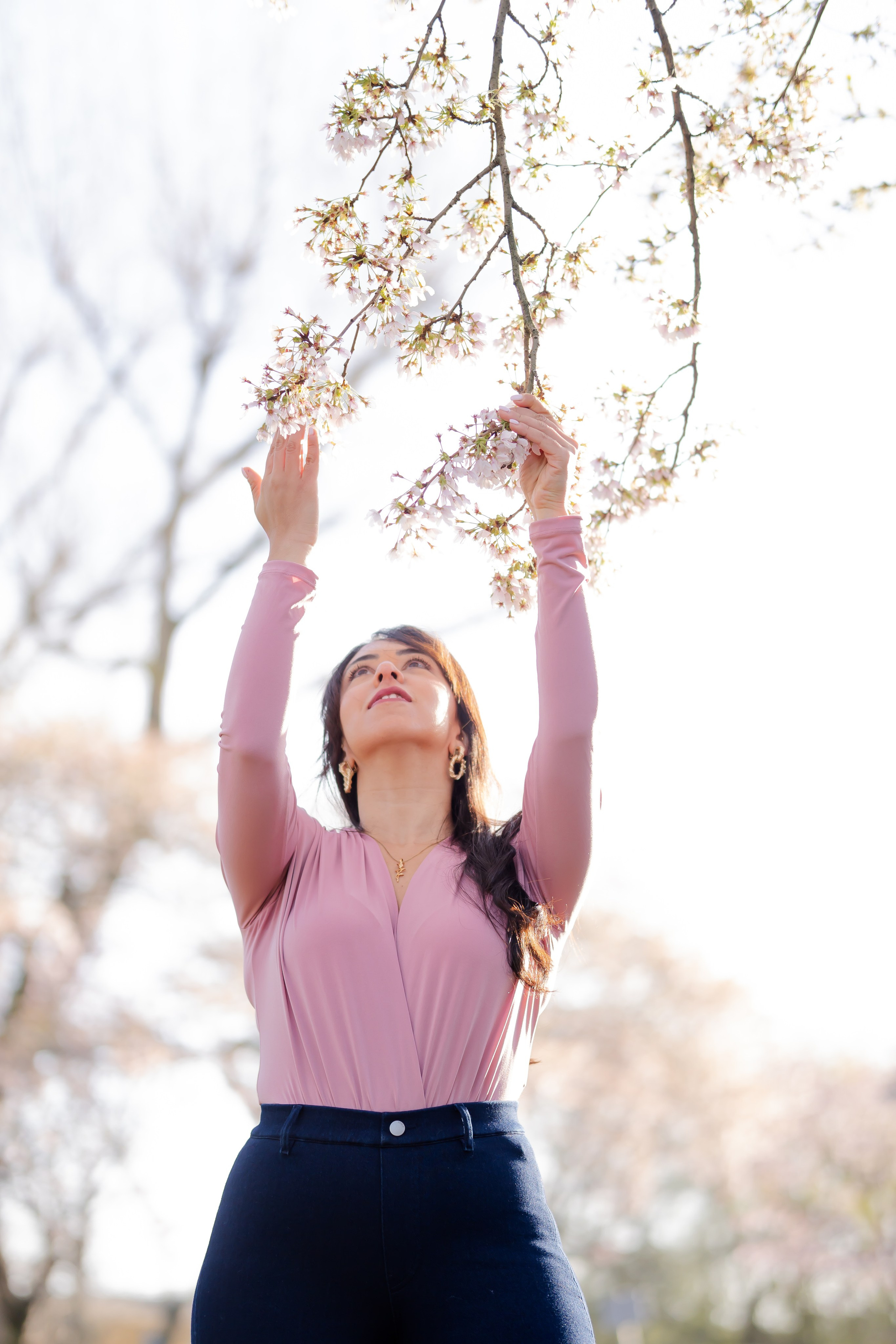 girl holding a cherry blossoms branch