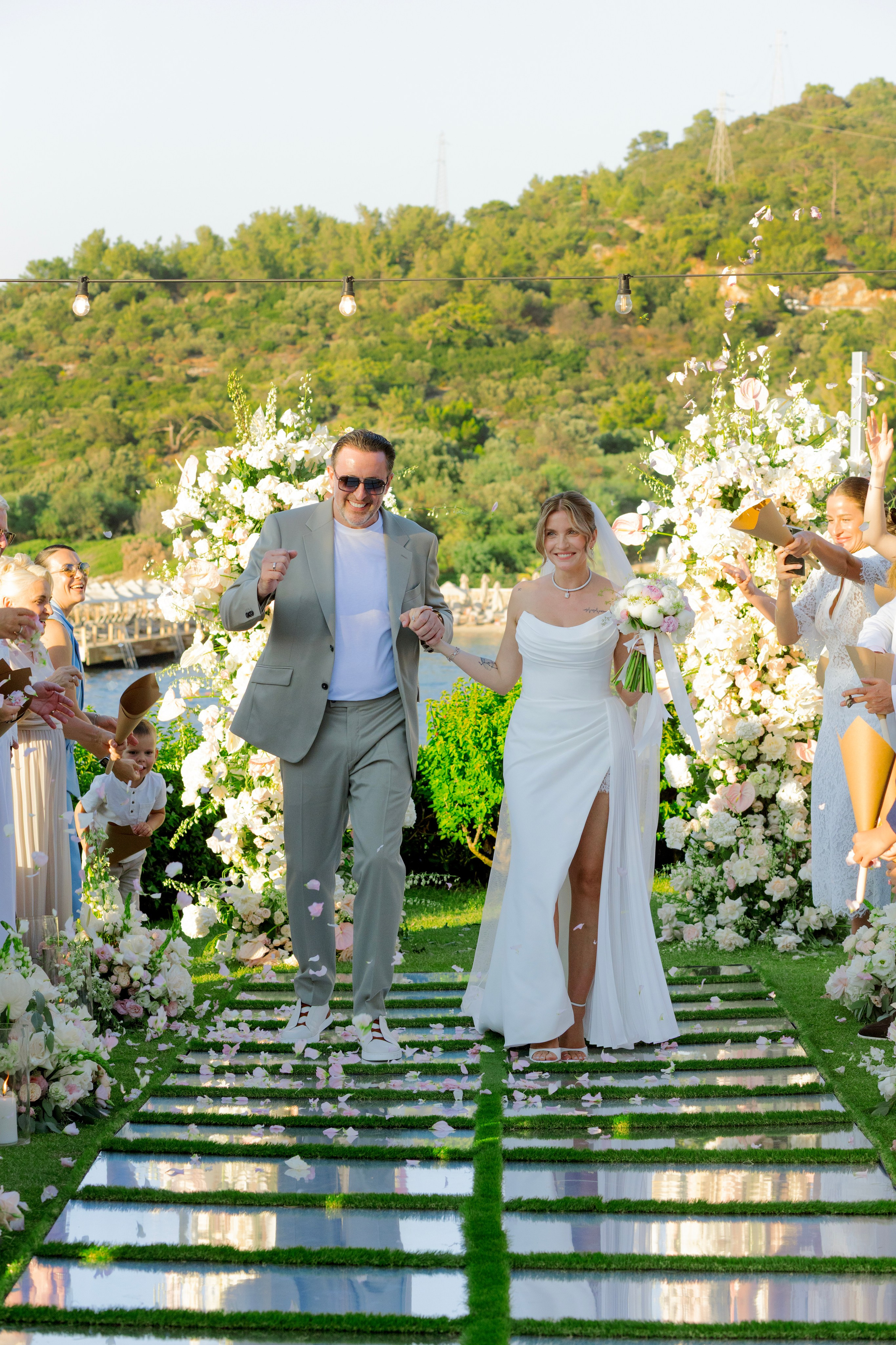 Newlyweds walking down a mirrored wedding aisle at Susona Bodrum