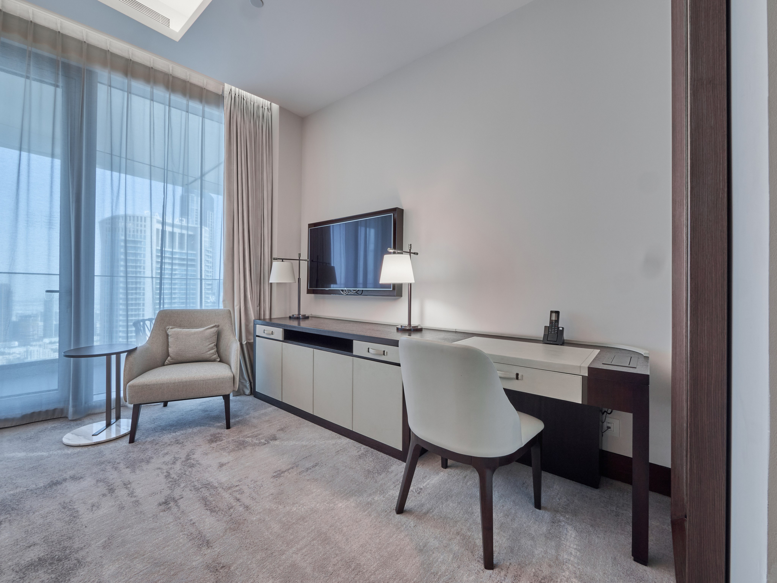 Modern workspace and TV area in a bright hotel room — photographed for real estate agents and vacation rental listings in Dubai.