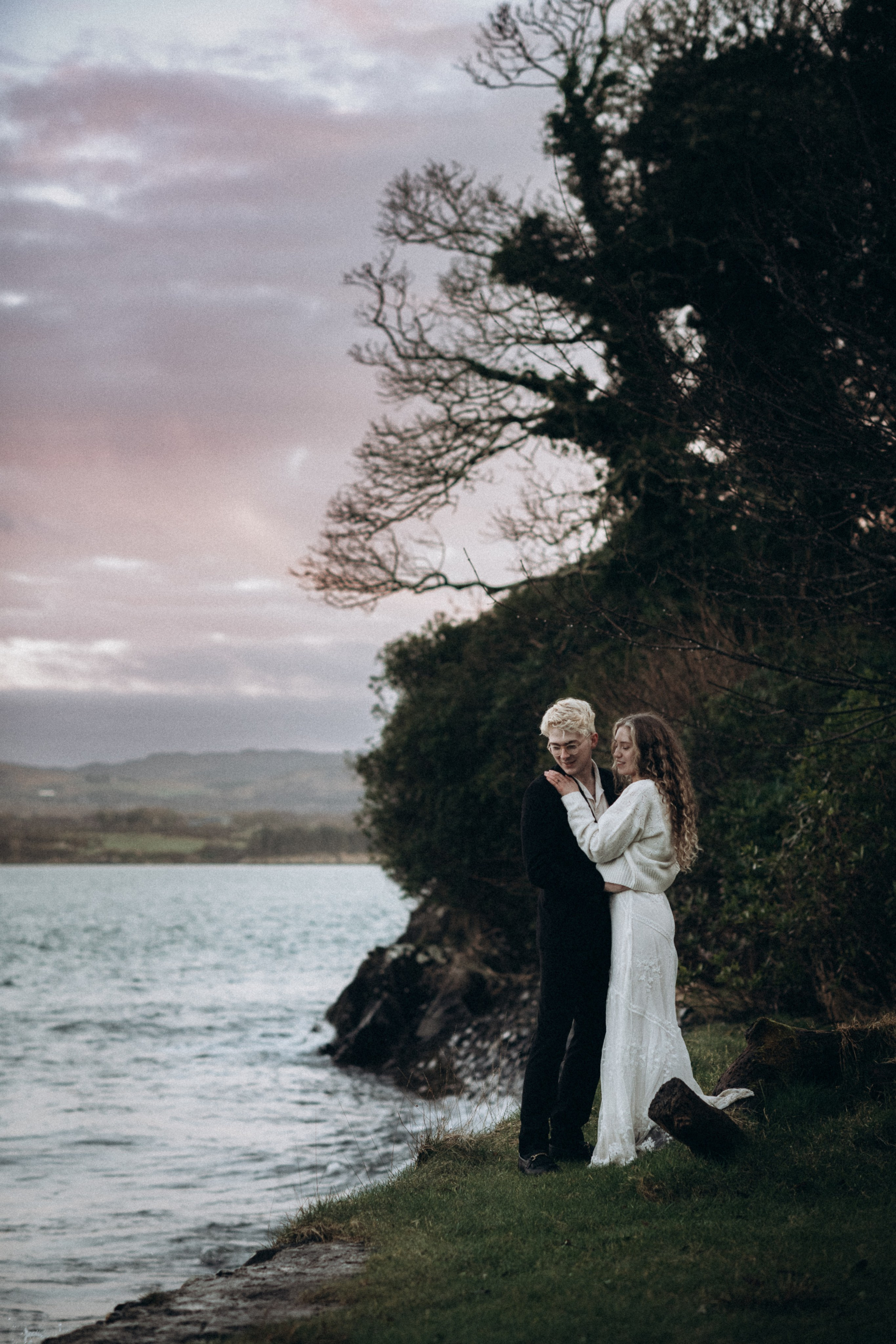 young beautiful couple sunset by the lake