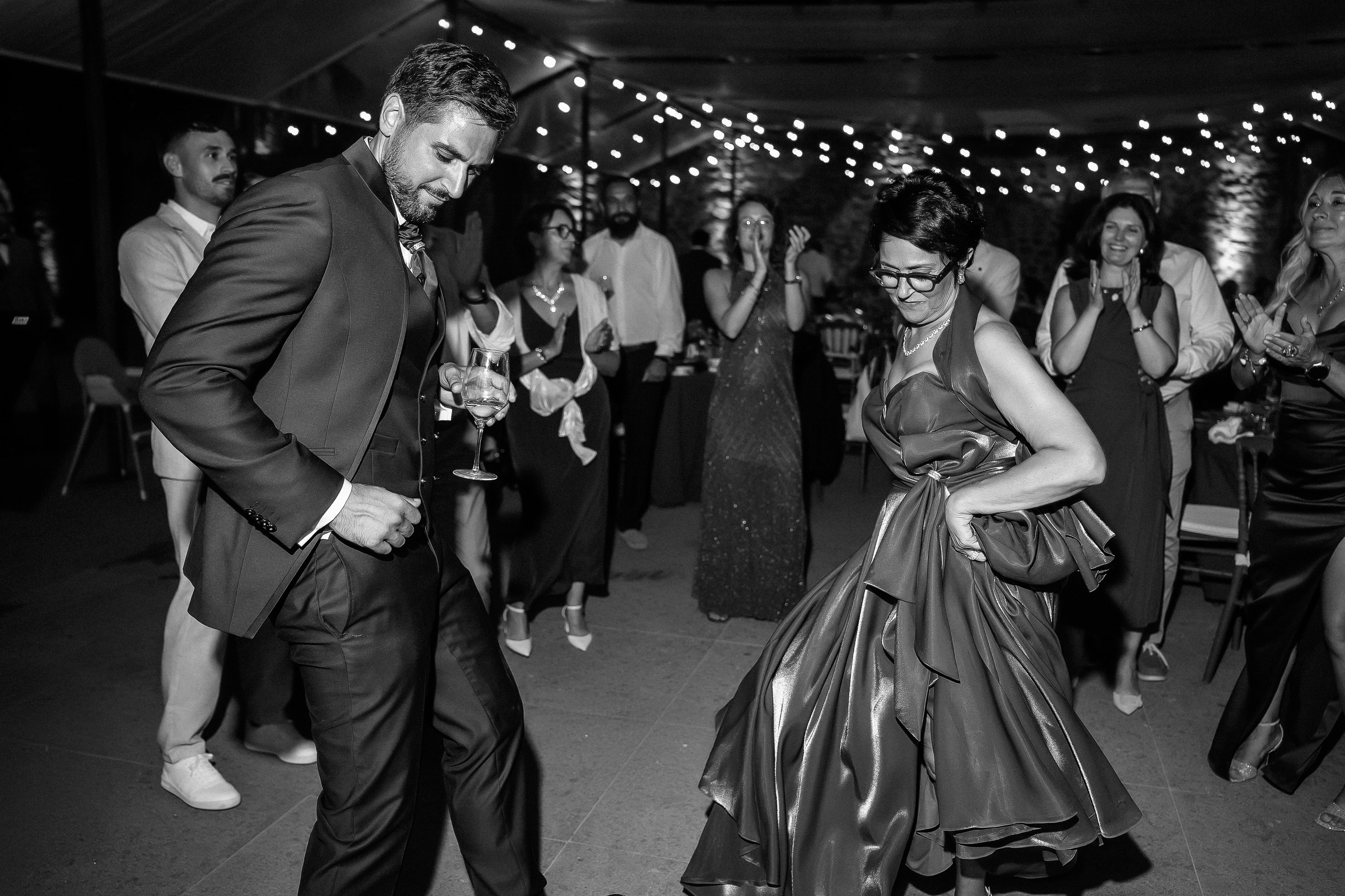 Black and white photo of guests dancing at the wedding party