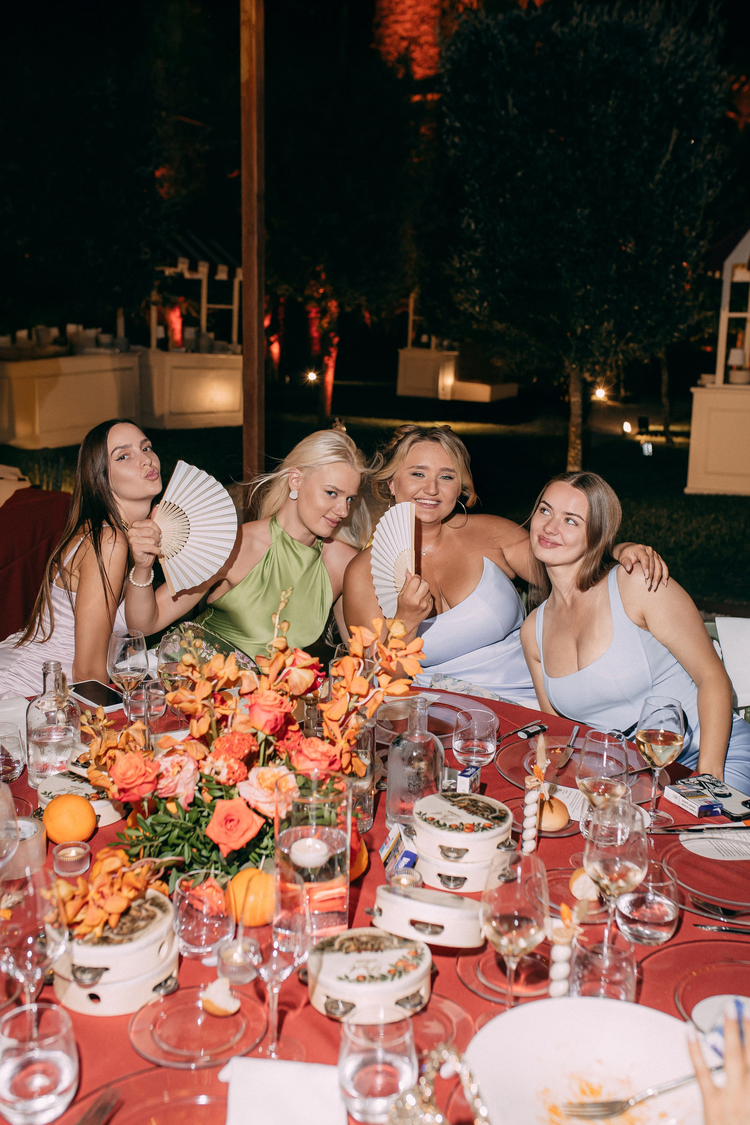 Guests laughing at the decorated dinner table in the evening