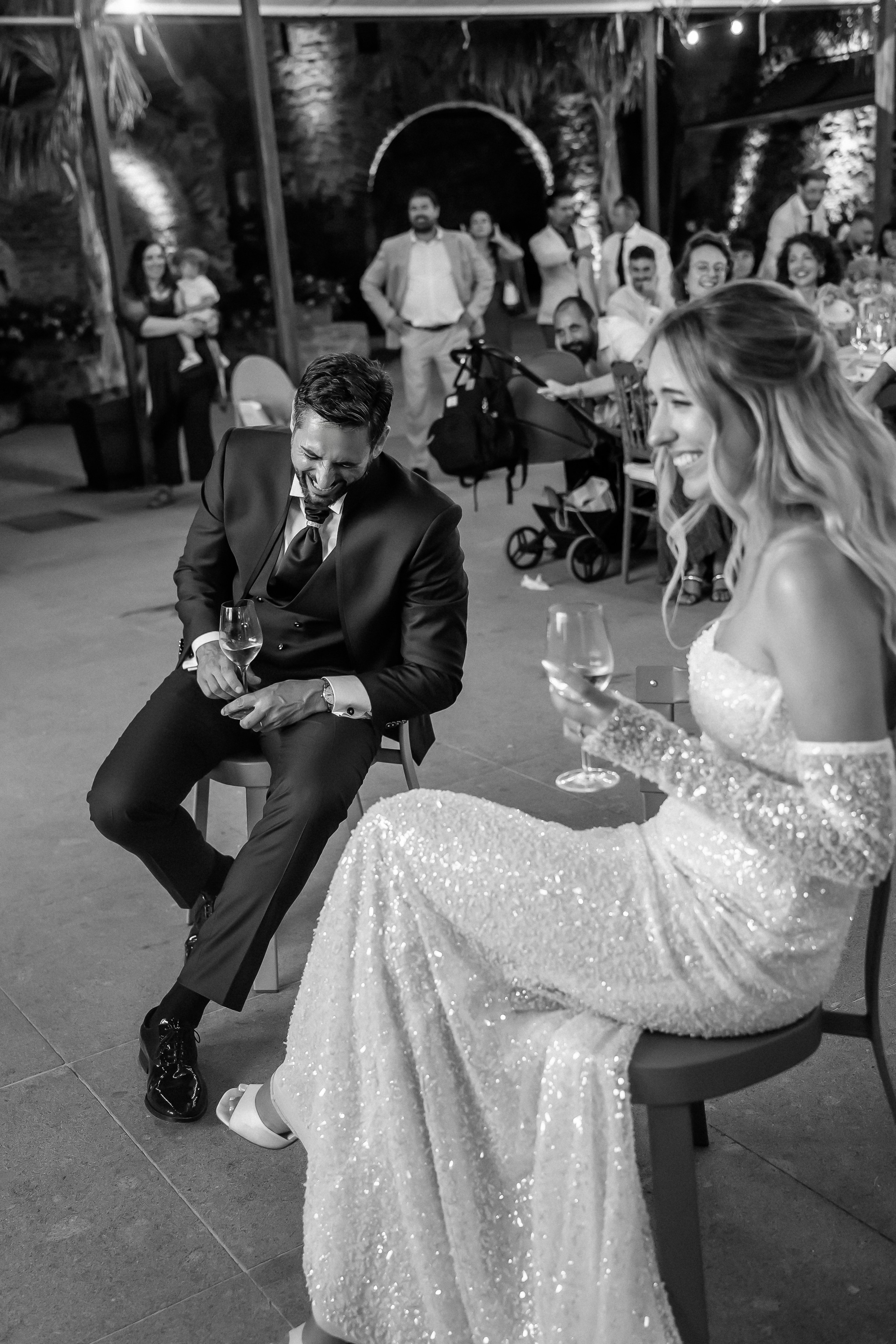 Bride and groom relaxing with drinks during the reception