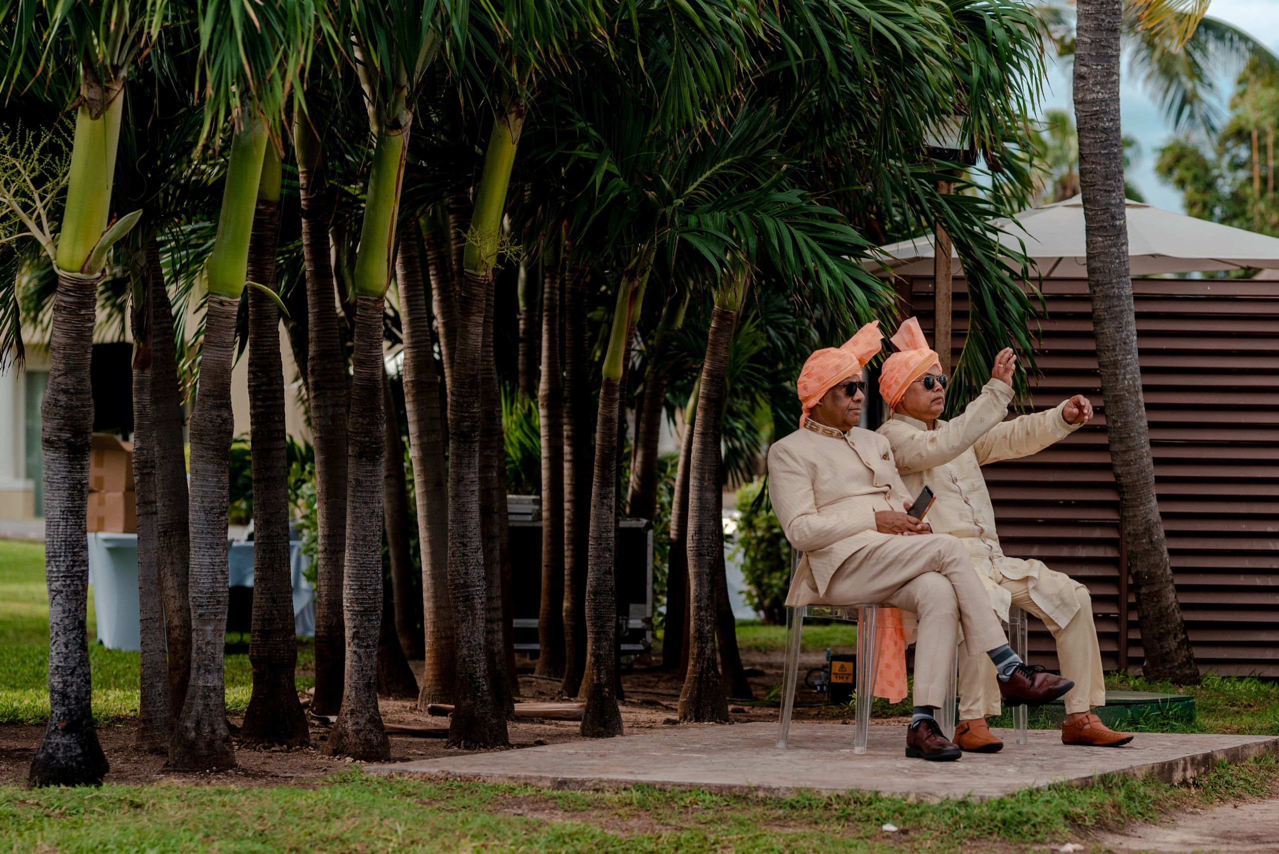Indian wedding elders wearing traditional attire waiting for the Baraat ceremony to begin in Cancun destination wedding