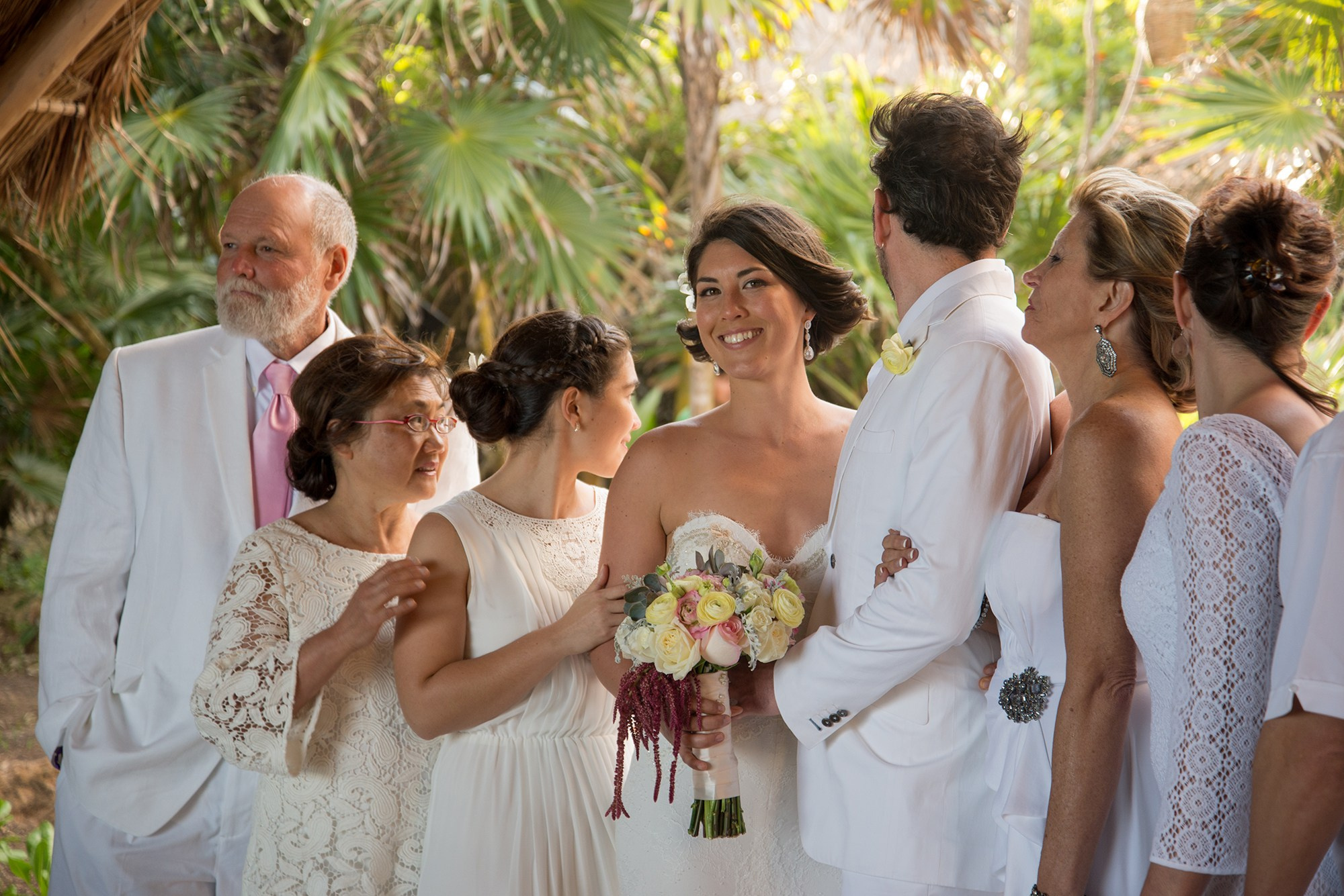 Candid bridal portrait in Los Cabos – bride during family celebration after beach wedding ceremony