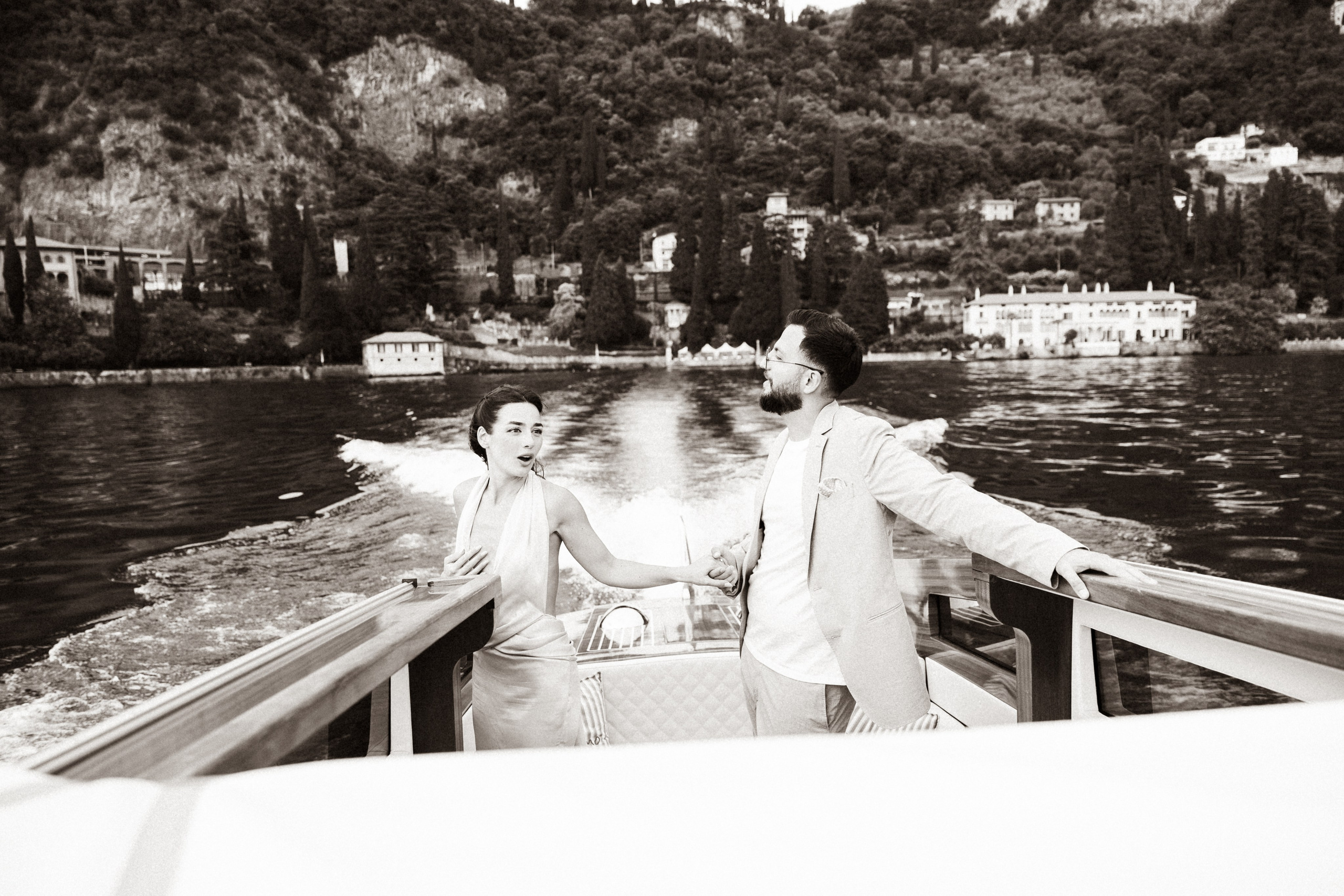 Romantic couple enjoying a boat ride on Lake Como during their engagement proposal