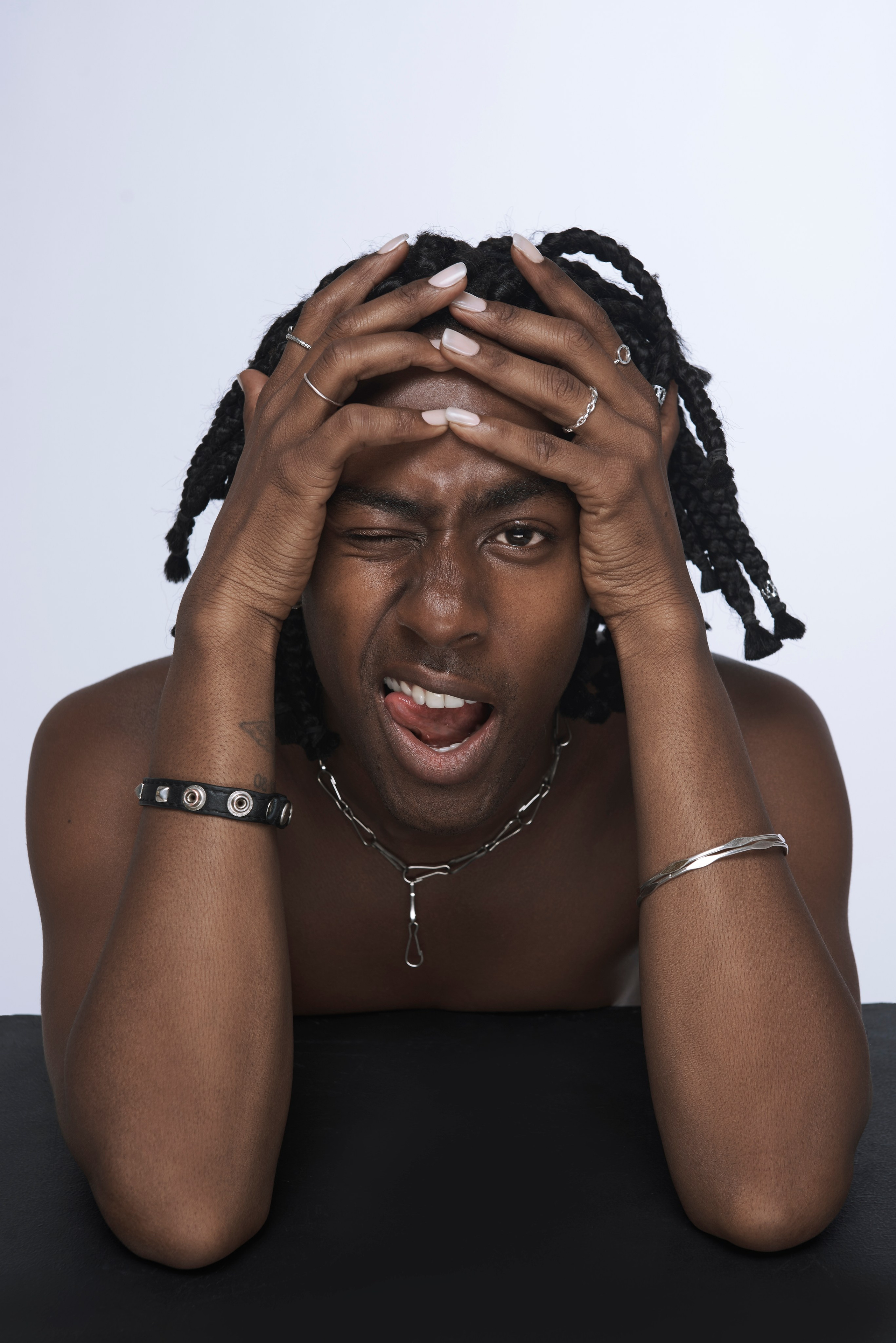 Emotional photo of a singer with tense hands near his head