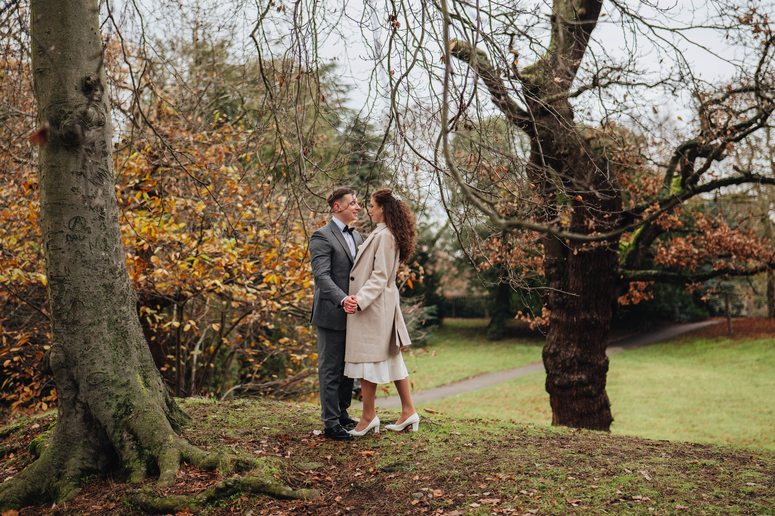 bride and groom kissing in the colourful autumn park