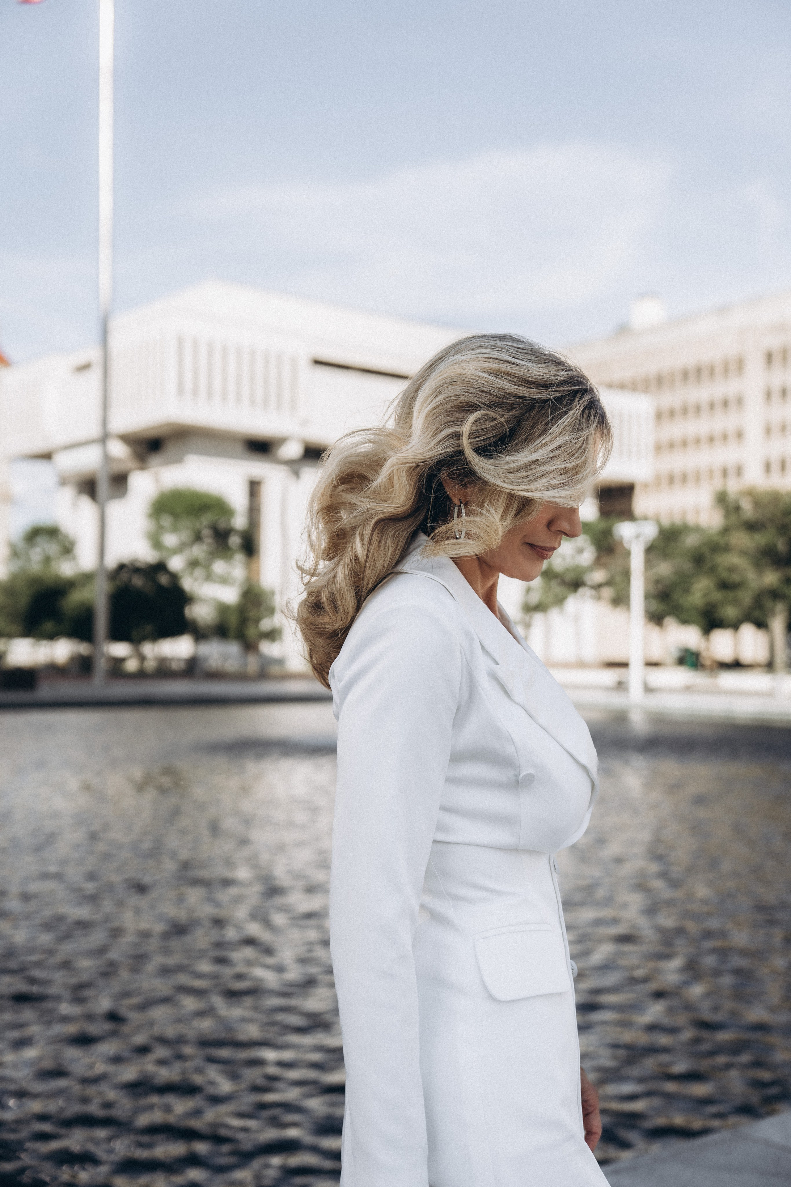 Joyful bride walking in Kingston riverfront park.
