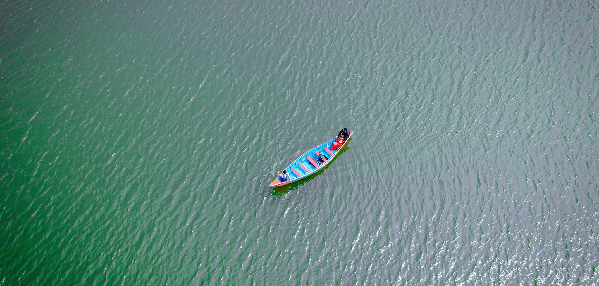 Aerial drone photography of a boat on a phewa lake for pre-wedding cinematics shoot by best wedding photographer in Nepal.