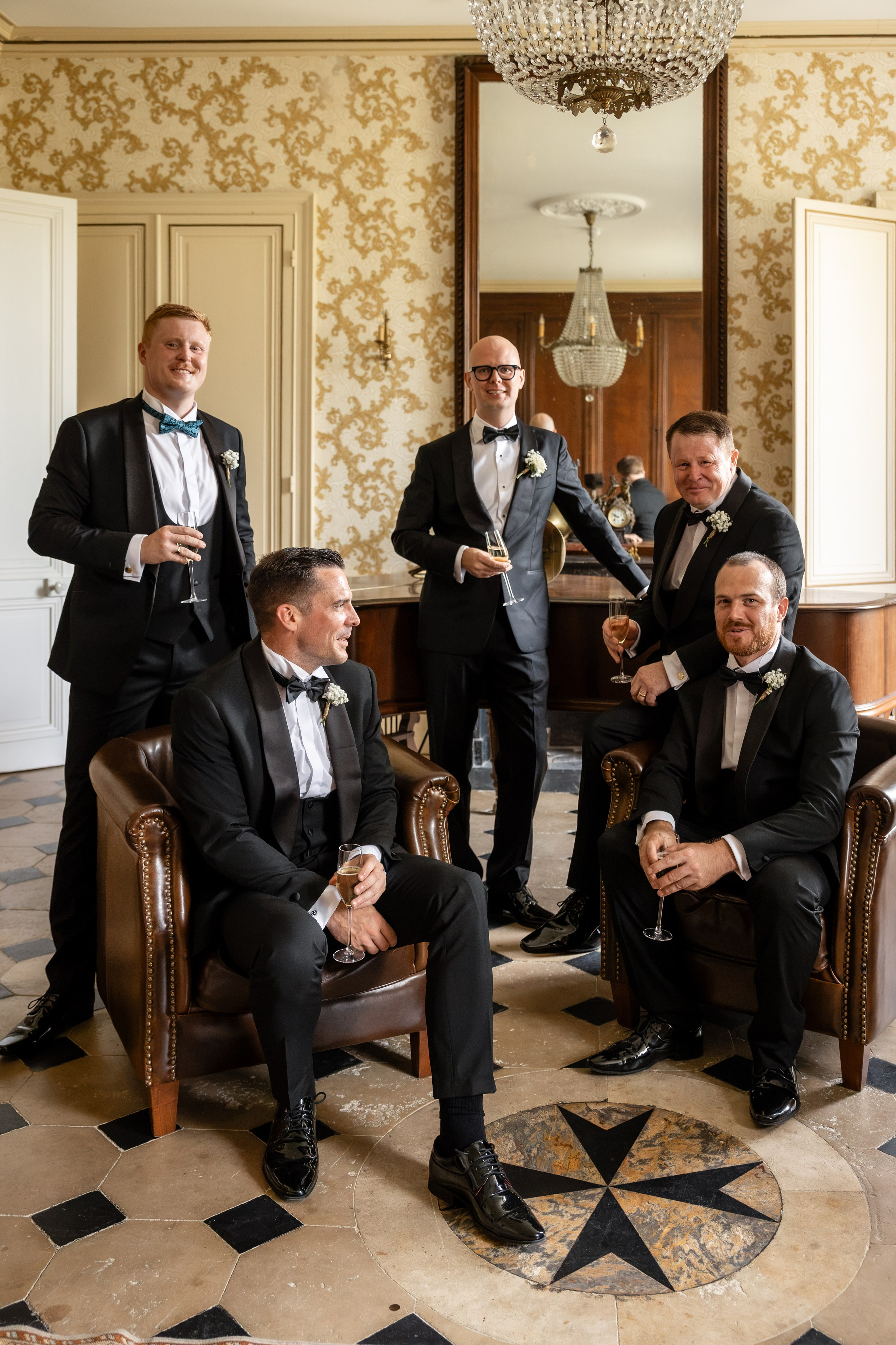 Groom and groomsmen in the salon at Château de la Borderie, Southwest France wedding
