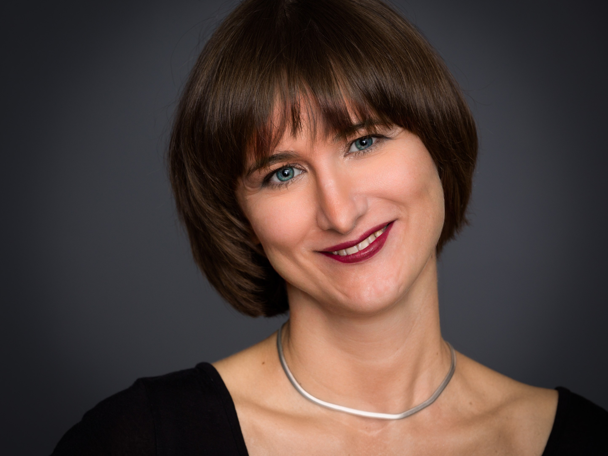 Portrait of a young lady on dark studio background - photographer Andrey Dunin