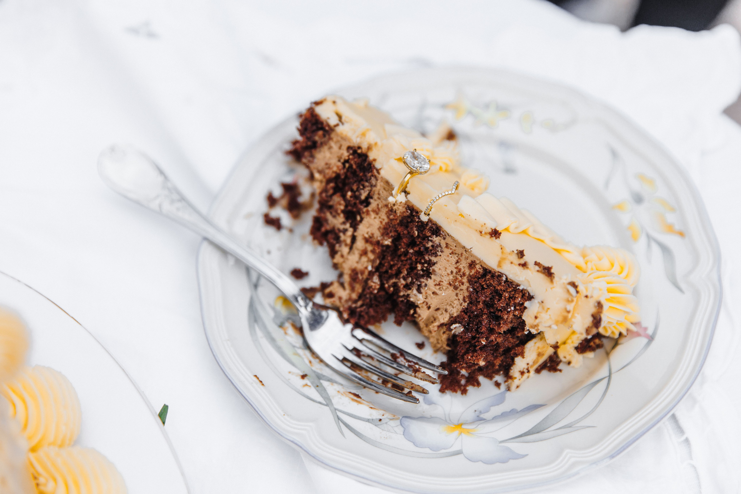Stunning multi-tiered wedding cake decorated with fresh flowers and intricate icing designs, displayed at a France wedding.
