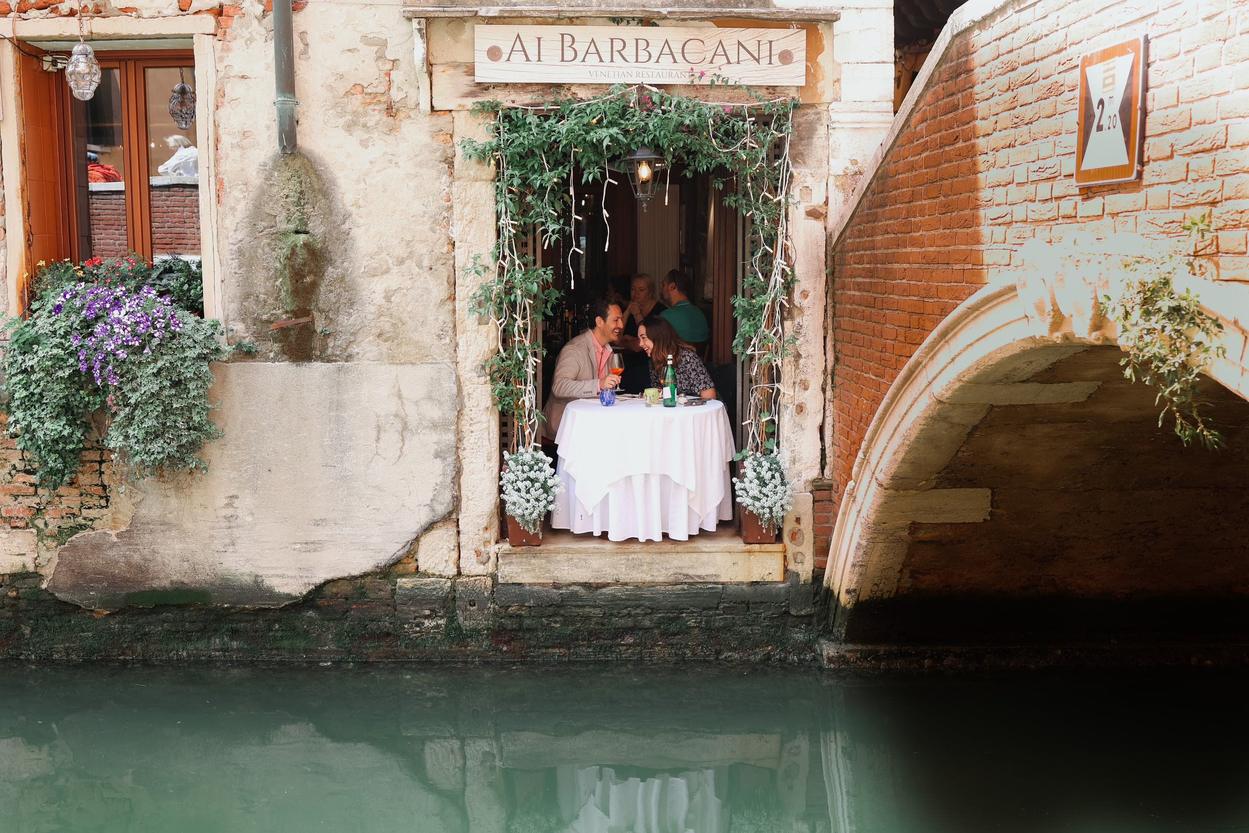 Against the romantic backdrop of Barbacani Restaurant , a couple celebrates their engagement, fine wine, and the enchanting Venetian tmosphere.