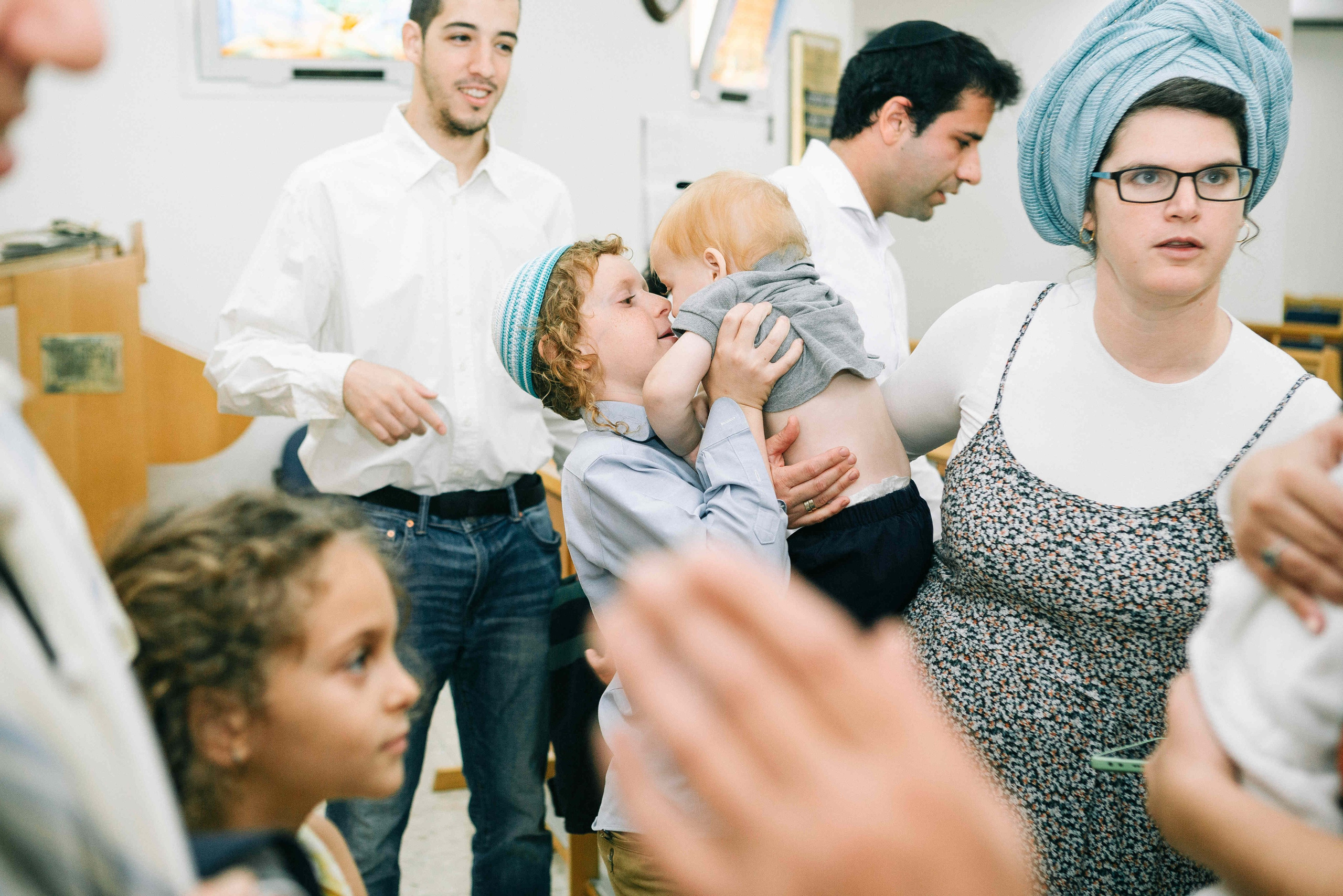 BRITH MILA IN THE SMALL SYNAGOGUE. PHOTOGRAPHER IN ISRAEL