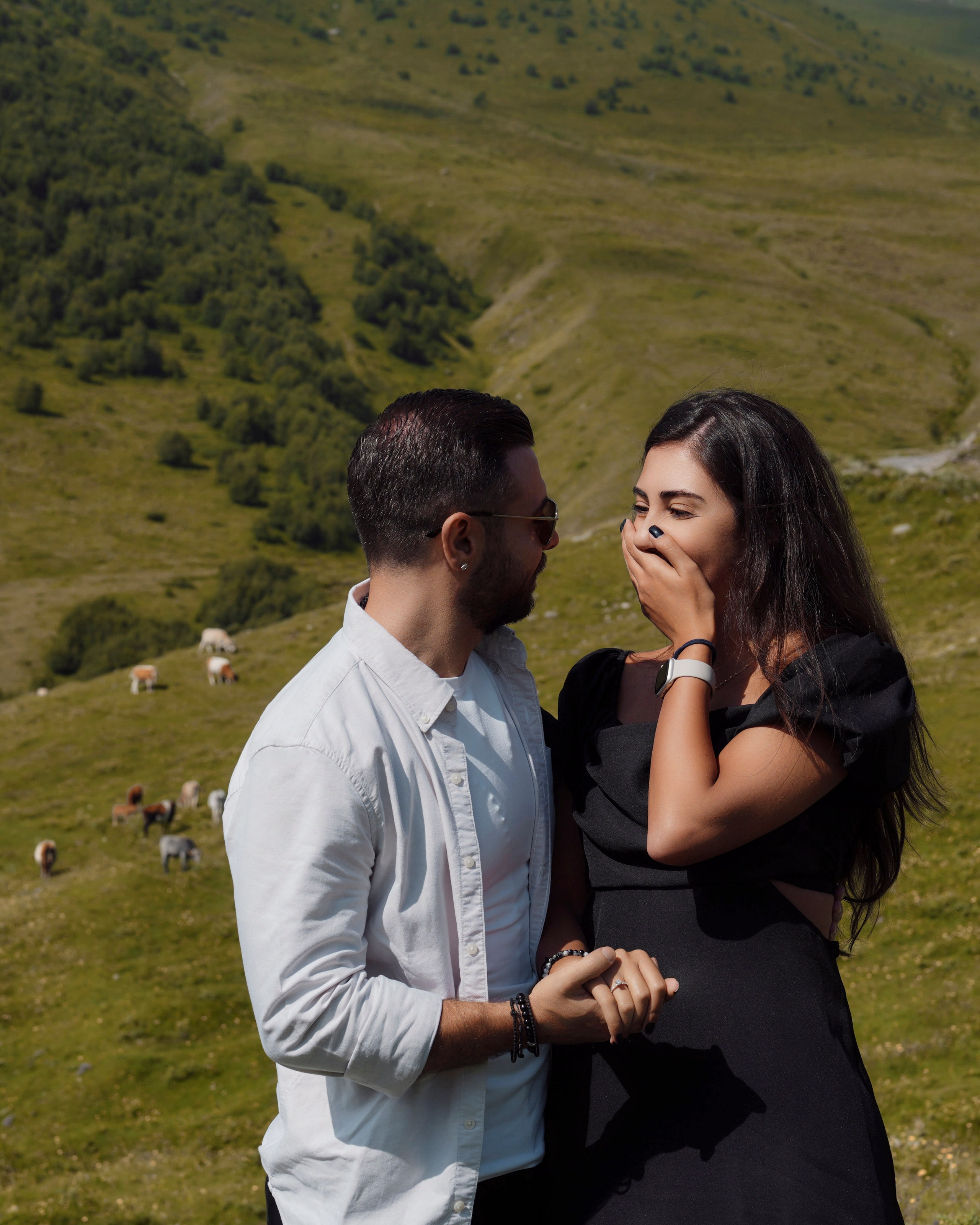 Couple laughing during photoshoot in Caucasus mountains Georgia