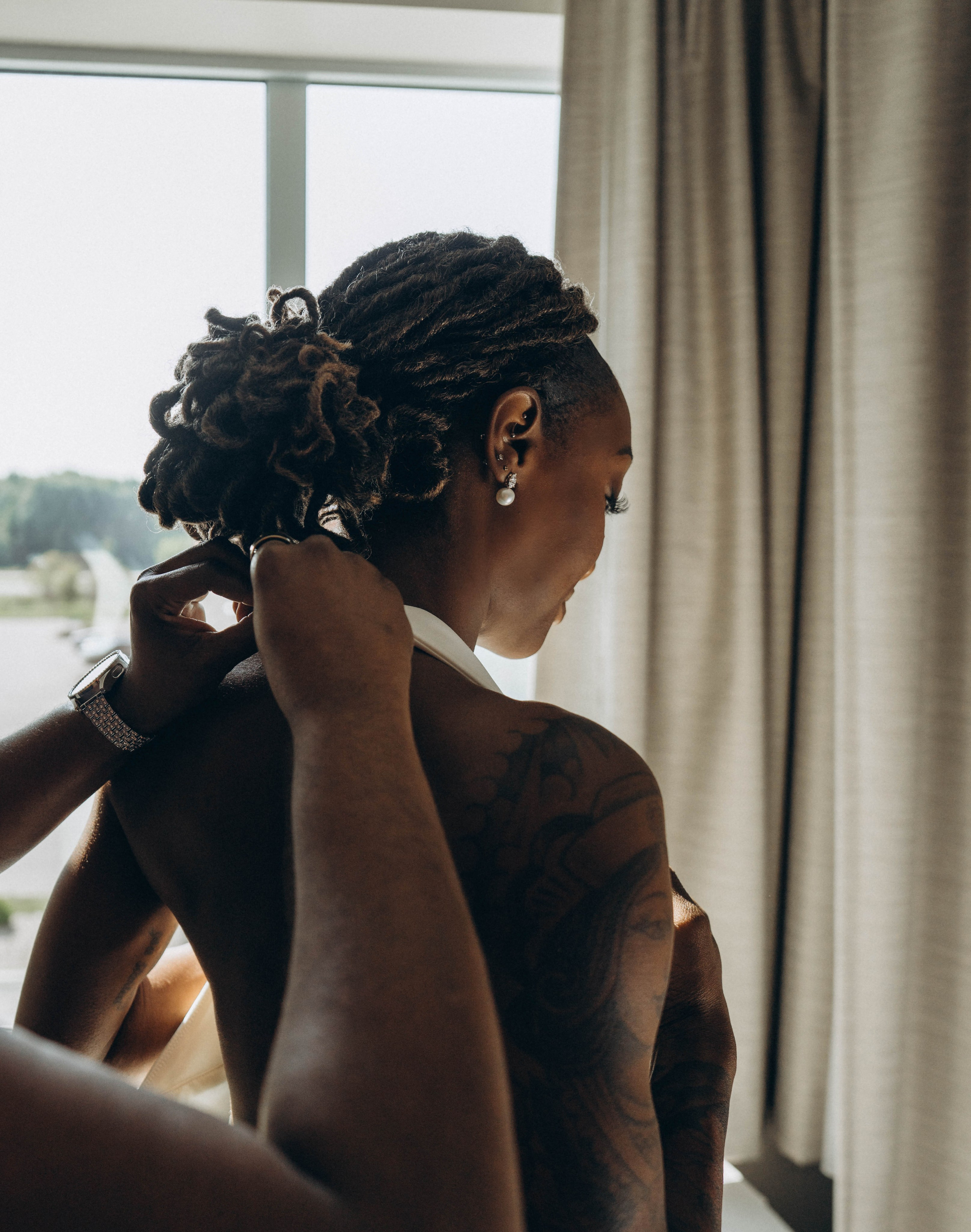 Bride in elegant gown on Syracuse city rooftop.