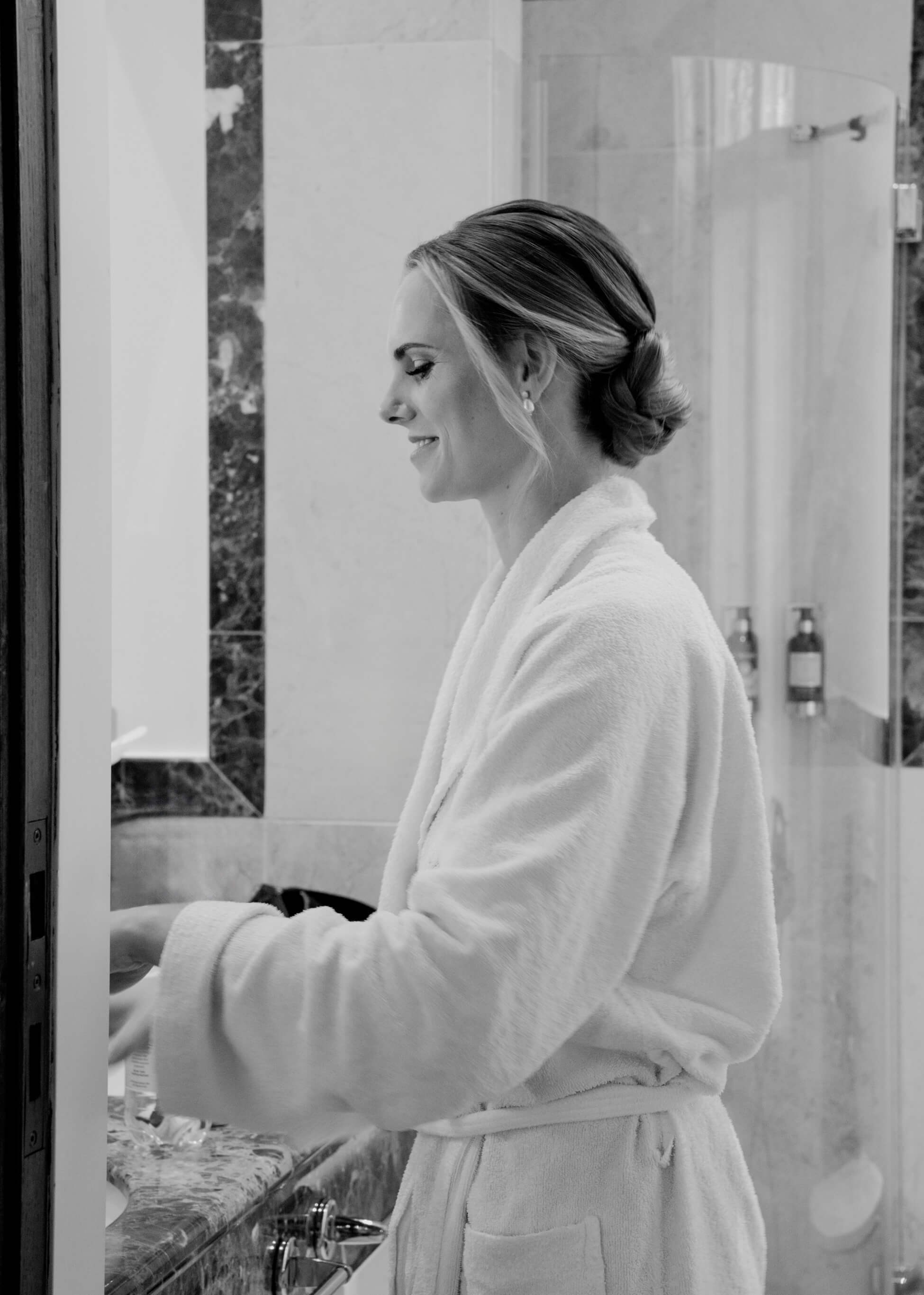 Bride in white bathrobe getting ready, bridal preparation at Villa Rothschild Frankfurt luxury wedding