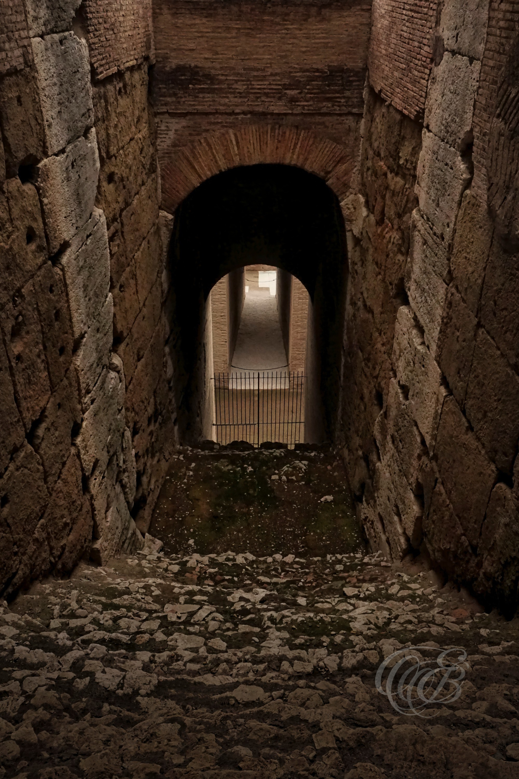 Rome, Italy — Lower Level Arched Stairway of the Colosseum — Eduardo Bartoli Photography — Photograph of a lower-level arched staircase within the Colosseum, showcasing vaulted Roman architecture, structural engineering, and historic passageways beneath the ancient amphitheater in Rome, Italy — Rome, Italy — Lower Level Arched Stairway of the Colosseum — Eduardo Bartoli Photography.