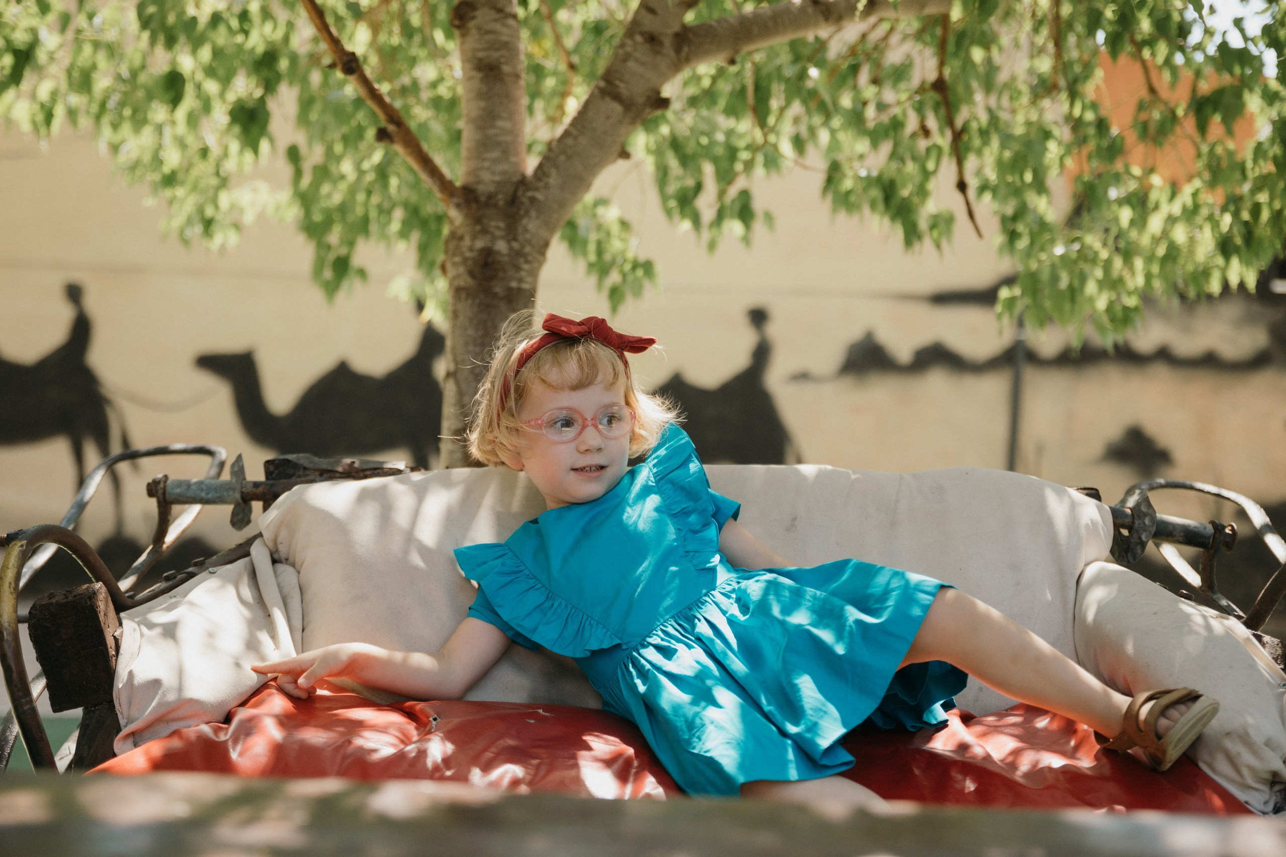 Joyful Moments in Camel park: Olya and Ada’s Day of Fun and Adventure, sliding and riding camels. Photographer in Barcelona capturing unique stories | Kate Chumak