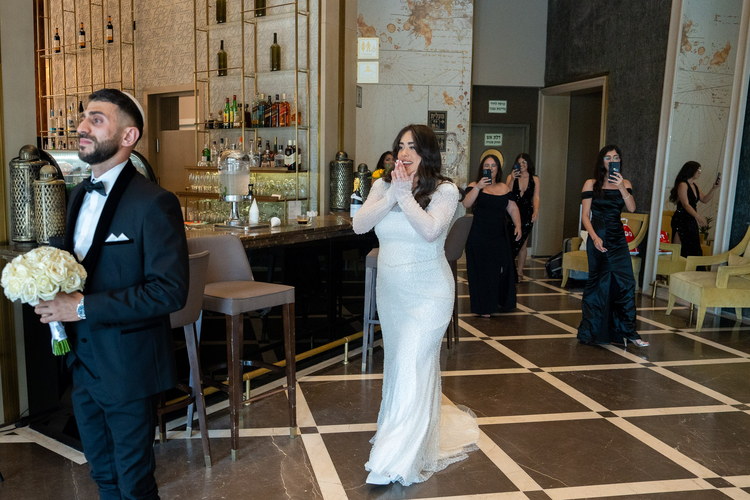 Bride Natali looking emotional while walking towards groom Shimon during their first look session in Netanya, Israel