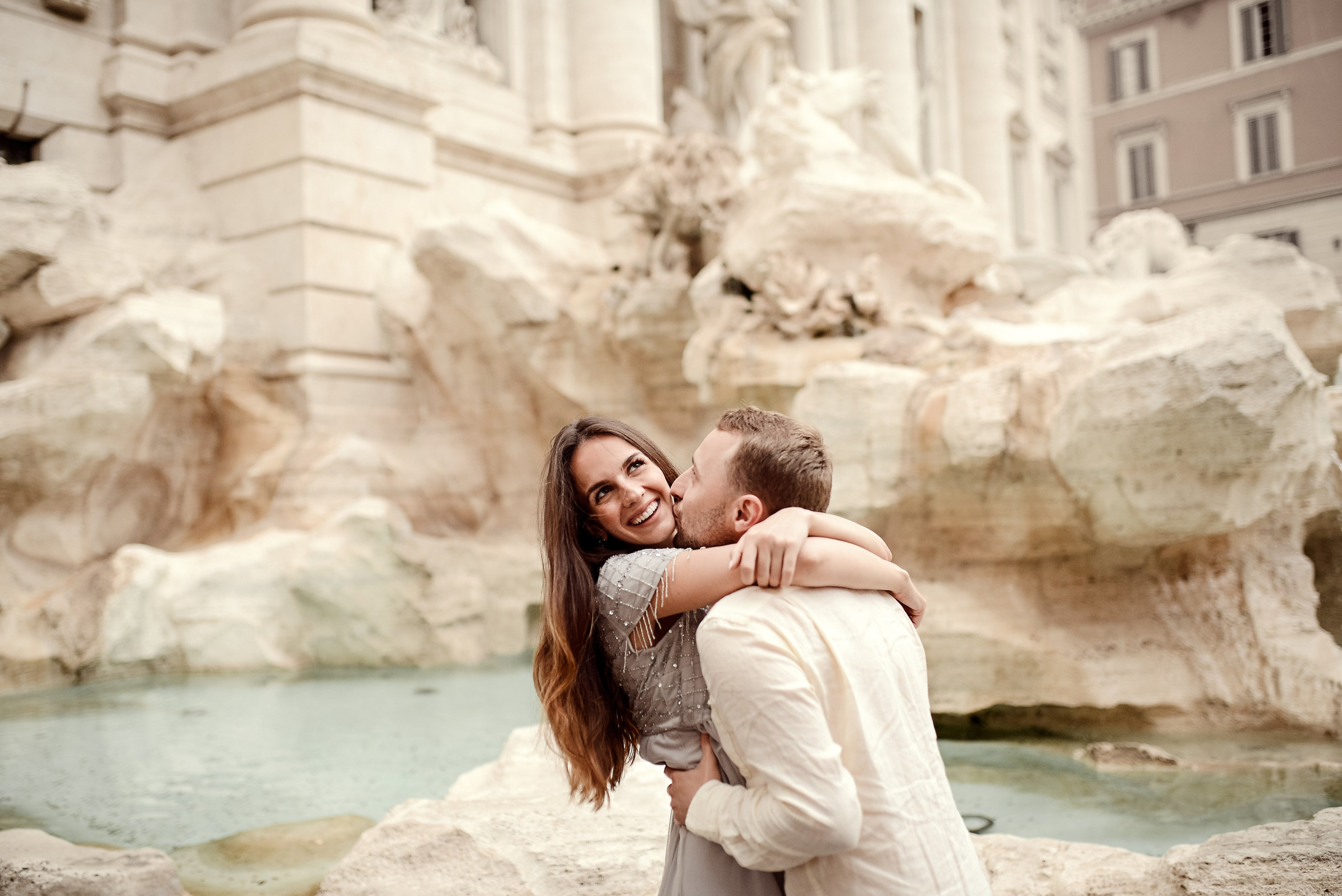 Couple embracing at Trevi Fountain in Rome