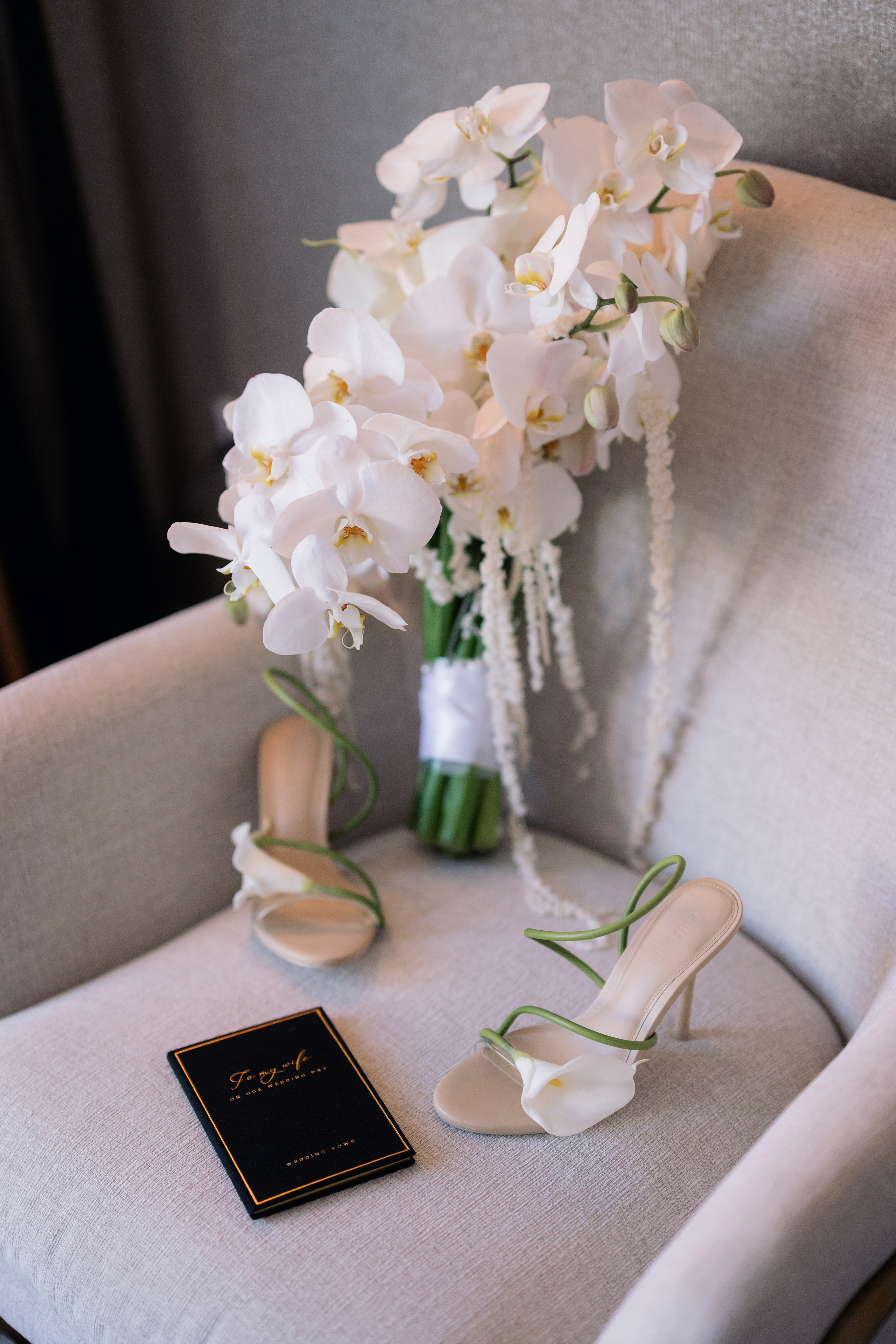 Wedding details with white bouquet, invitation suite, and bridal accessories