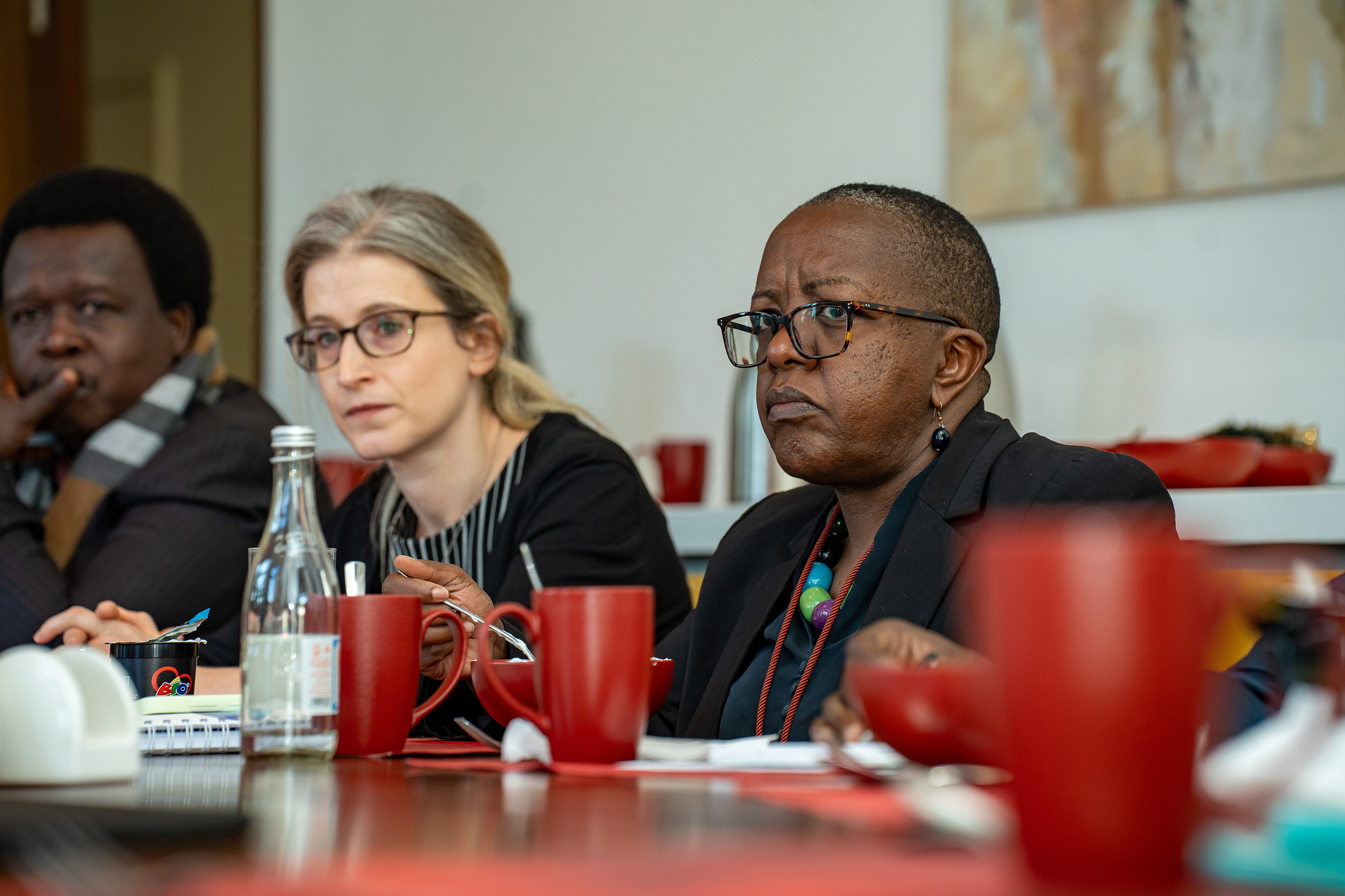 A close-up portrait of an attentive business lady at a corporate event in Nairobi.
