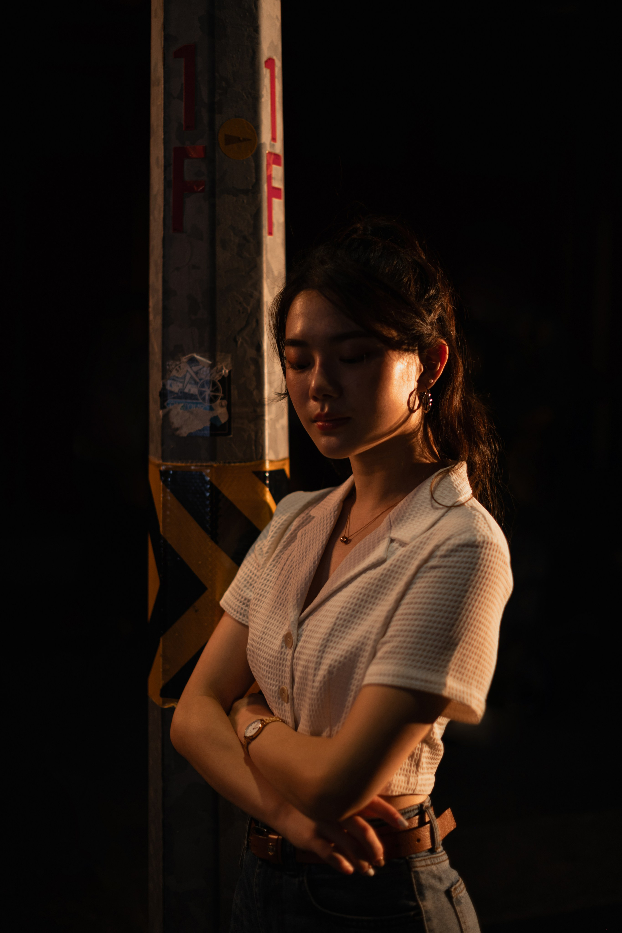 Atmospheric Singapore urban scene with reflective pavement and dramatic street lighting. An editorial image by a freelance photographer capturing the essence of modern street photography with innovative, artistic lighting.