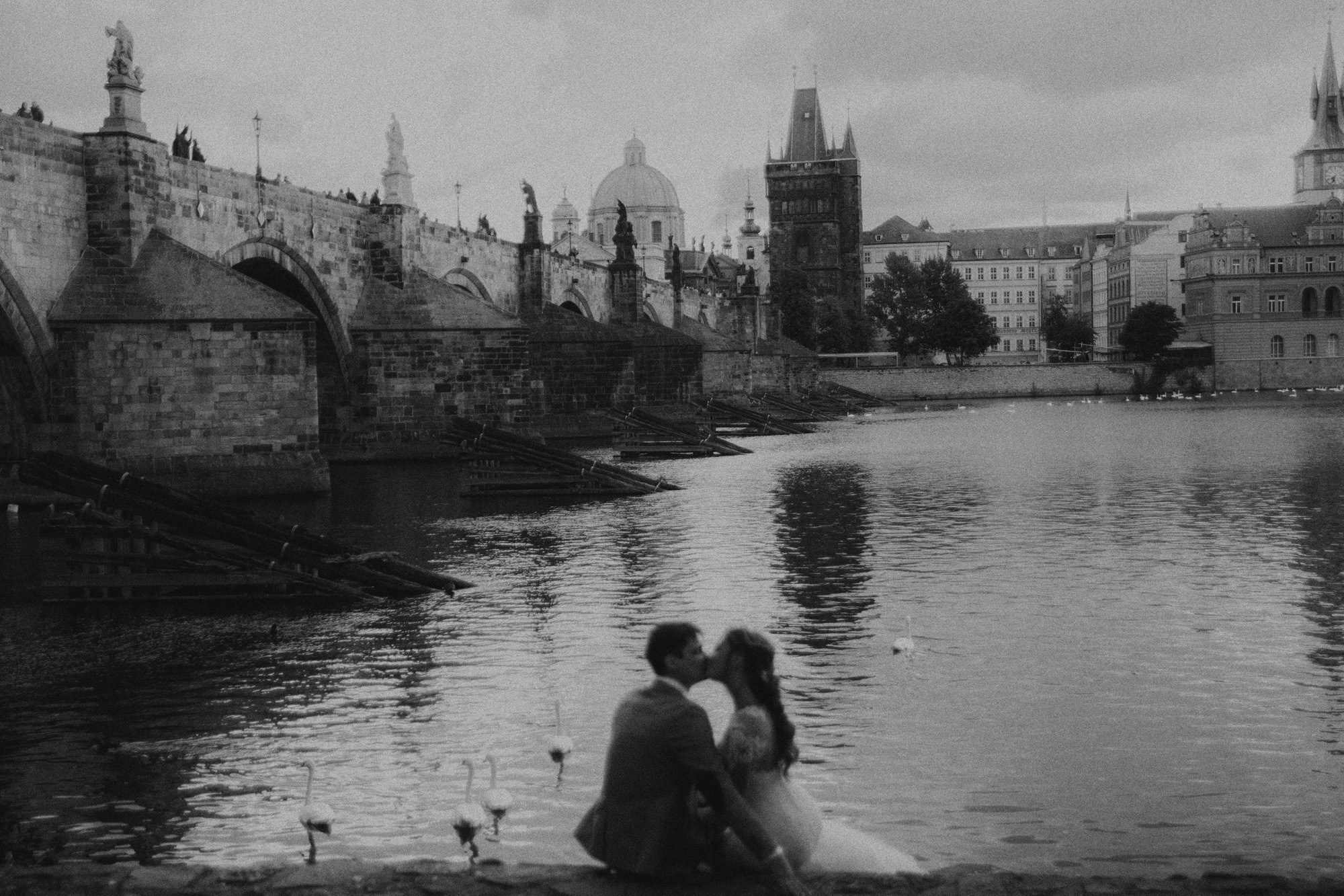 couple on the background of Charles bridge in Prague 