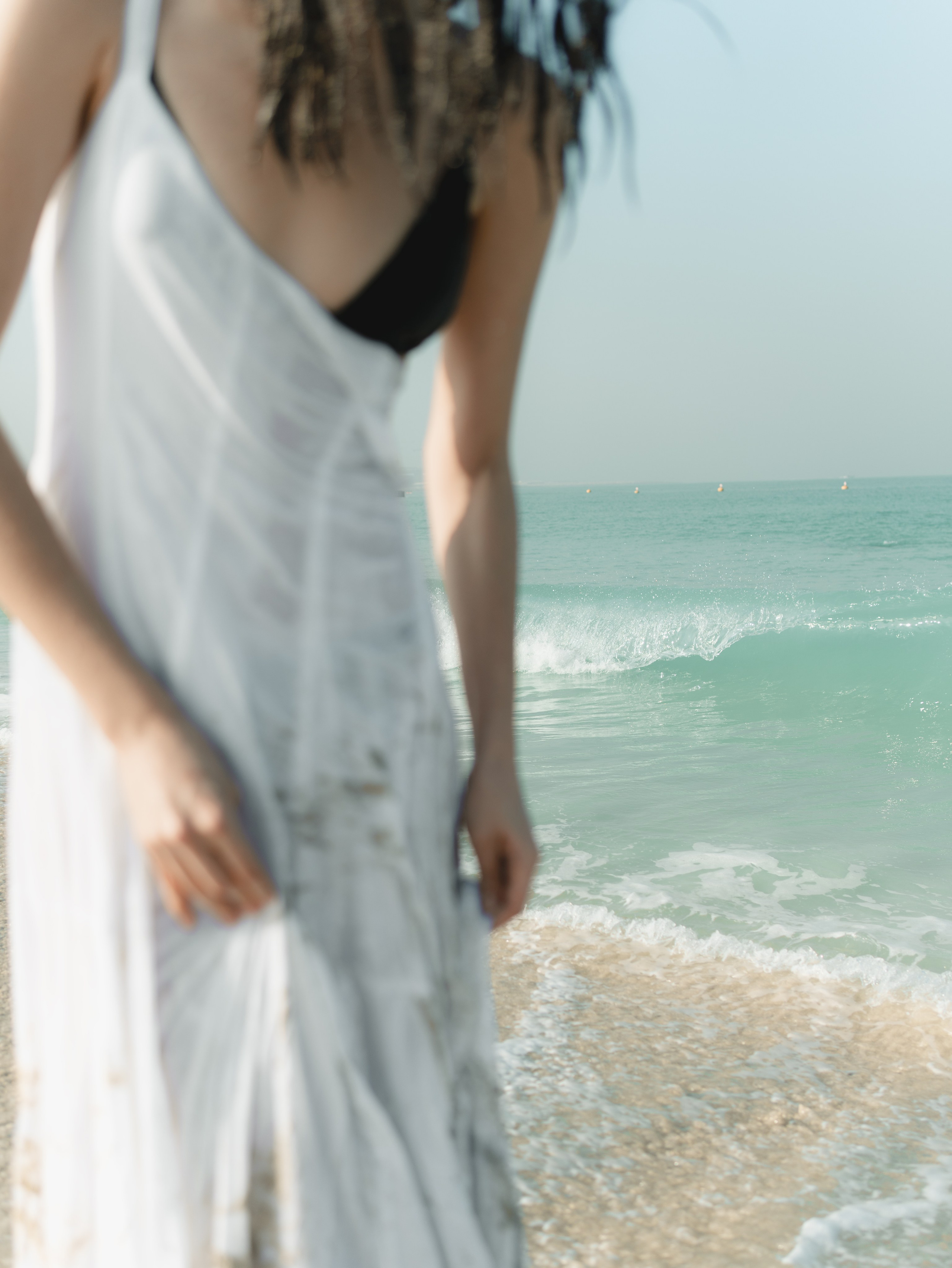 Fashion portrait series on the beach in minimalistic swimwear look. Alisha Geva | Contemporary fashion women’s portrait Dubai