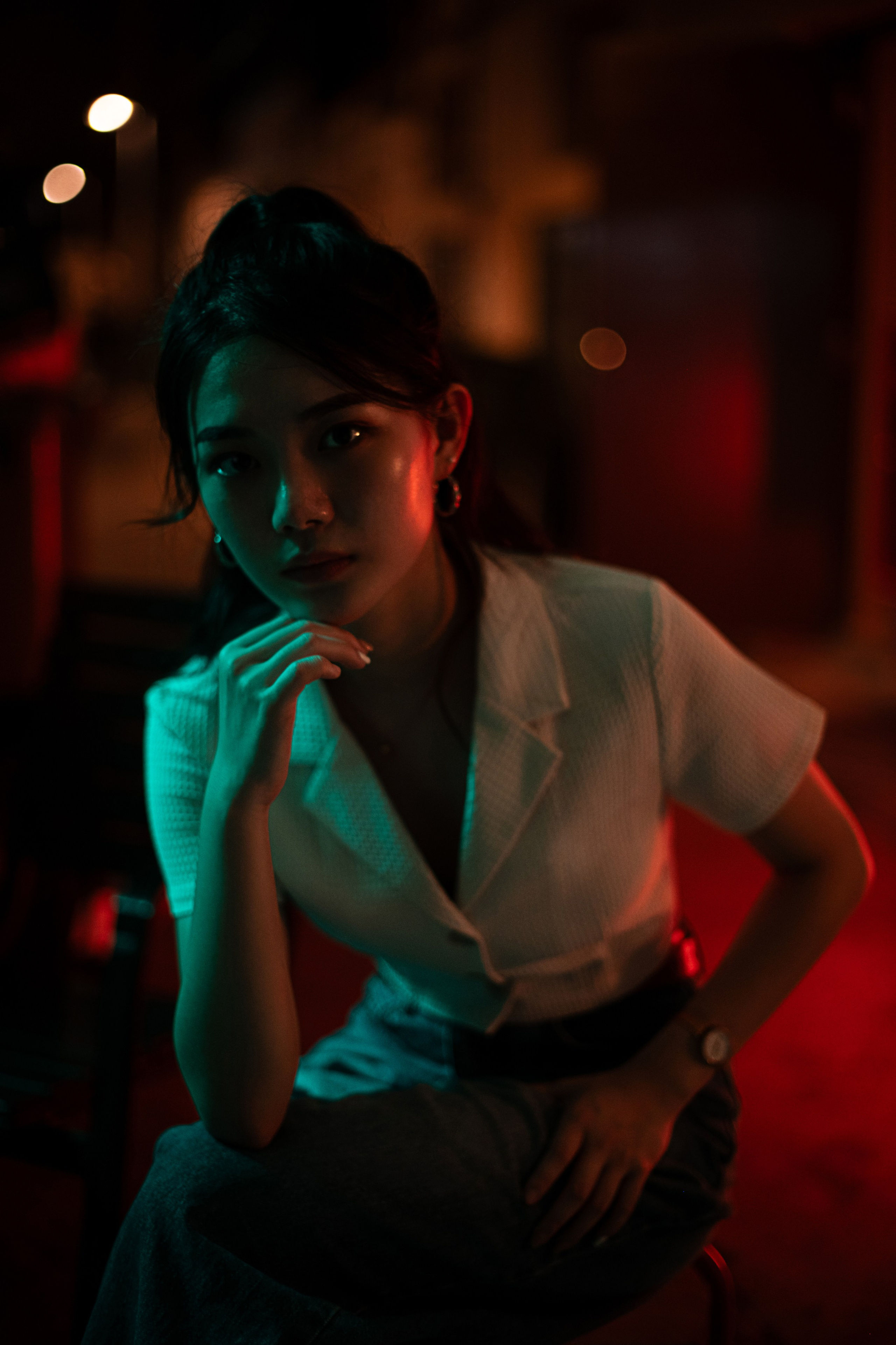 Striking Singapore nightscape with a glowing street light illuminating bustling urban streets. This editorial photograph by a freelance photographer showcases creative urban aesthetics and bold composition for commercial appeal.