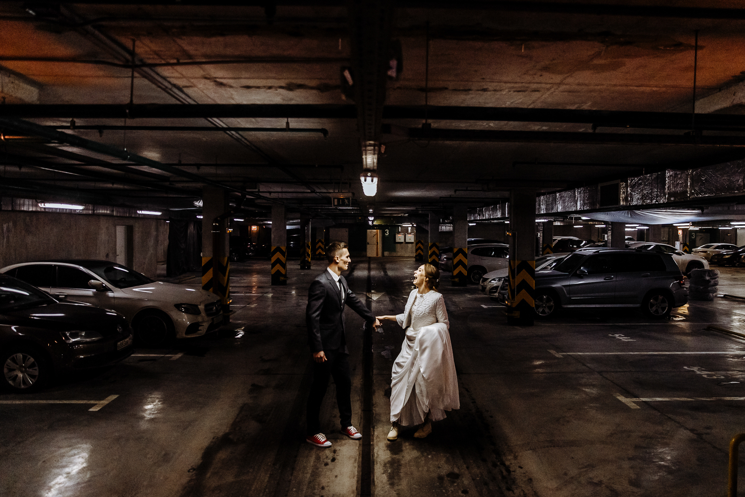 Couple posing in car park, by Tanya Bogdan, Bude wedding photography.  
