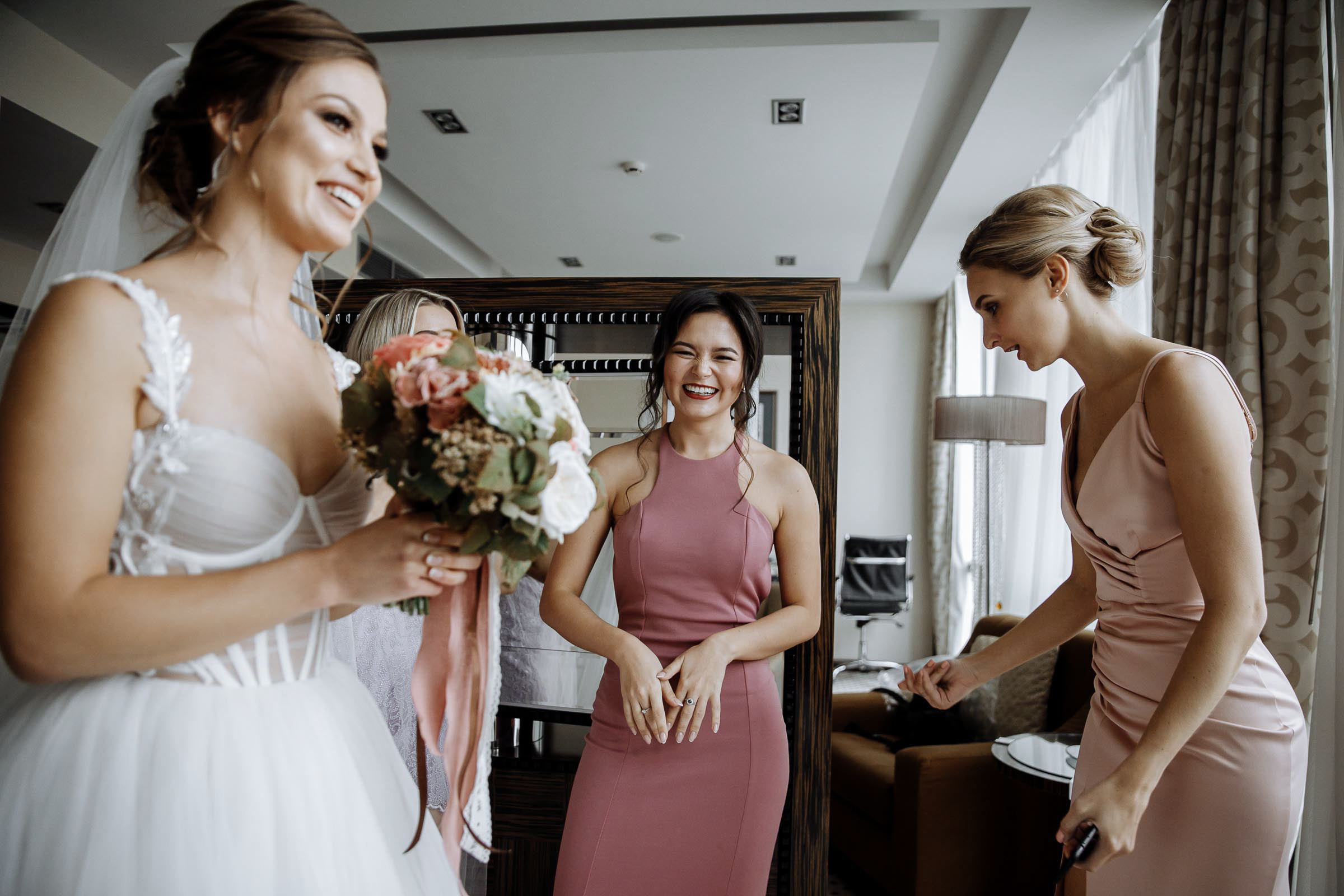 Bridesmaids in room with bride, by Tanya Bodgan, Falmouth wedding photography.  