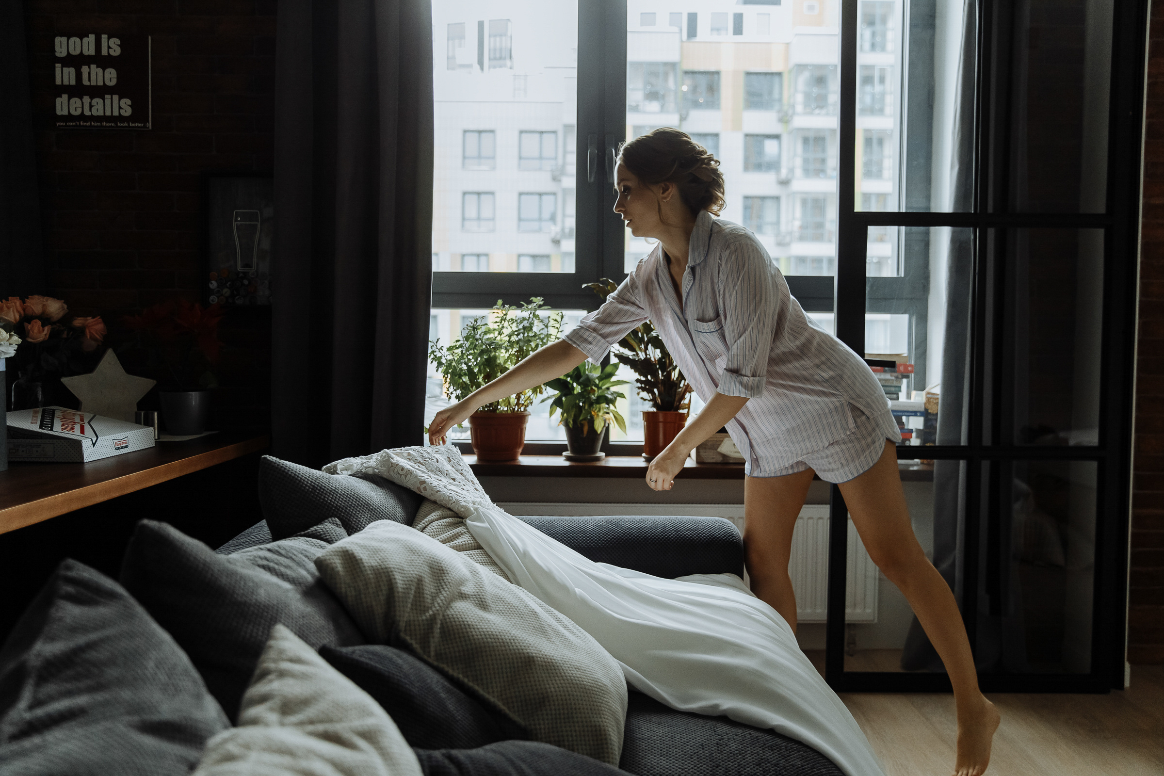 Bride preparing dress, by Tanya Bogdan, London wedding photography.  